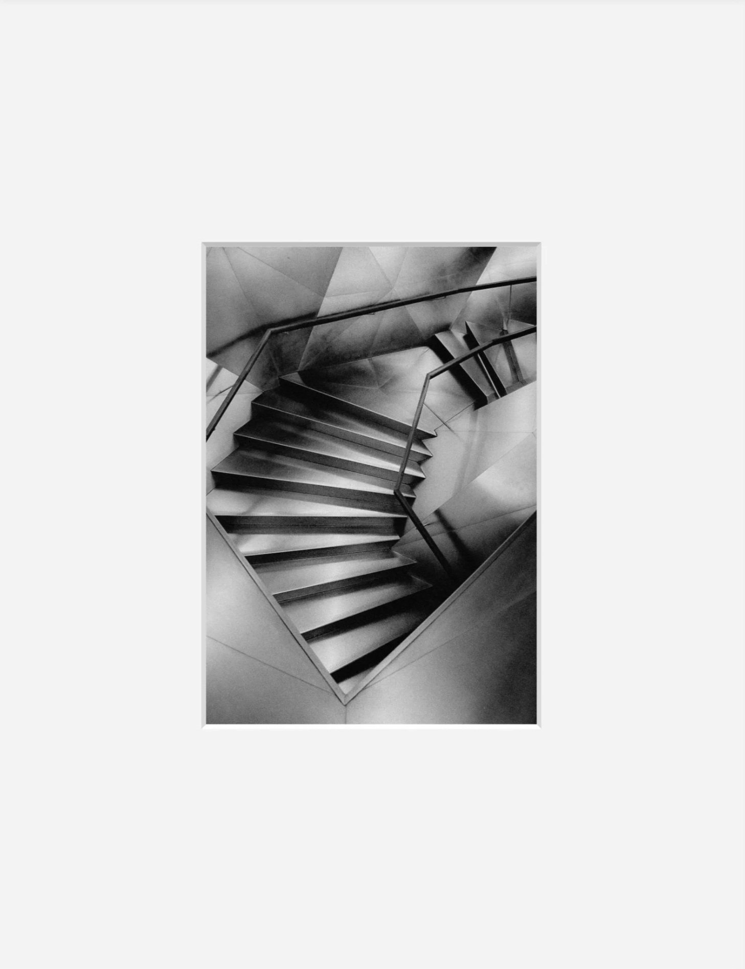 Fine art black and white architectural photography print CaixaForum Descent showing the faceted steel spiral staircase at CaixaForum Madrid by BAIIDA Paul Baidatsky