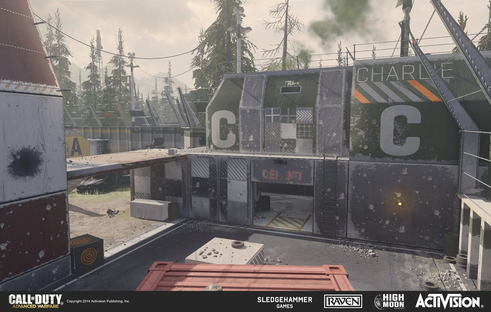 A map from the video game 'Call of Duty: Advanced Warfare' showing a rundown, industrial-style building with graffiti, tires, and debris, surrounded by trees and power lines.