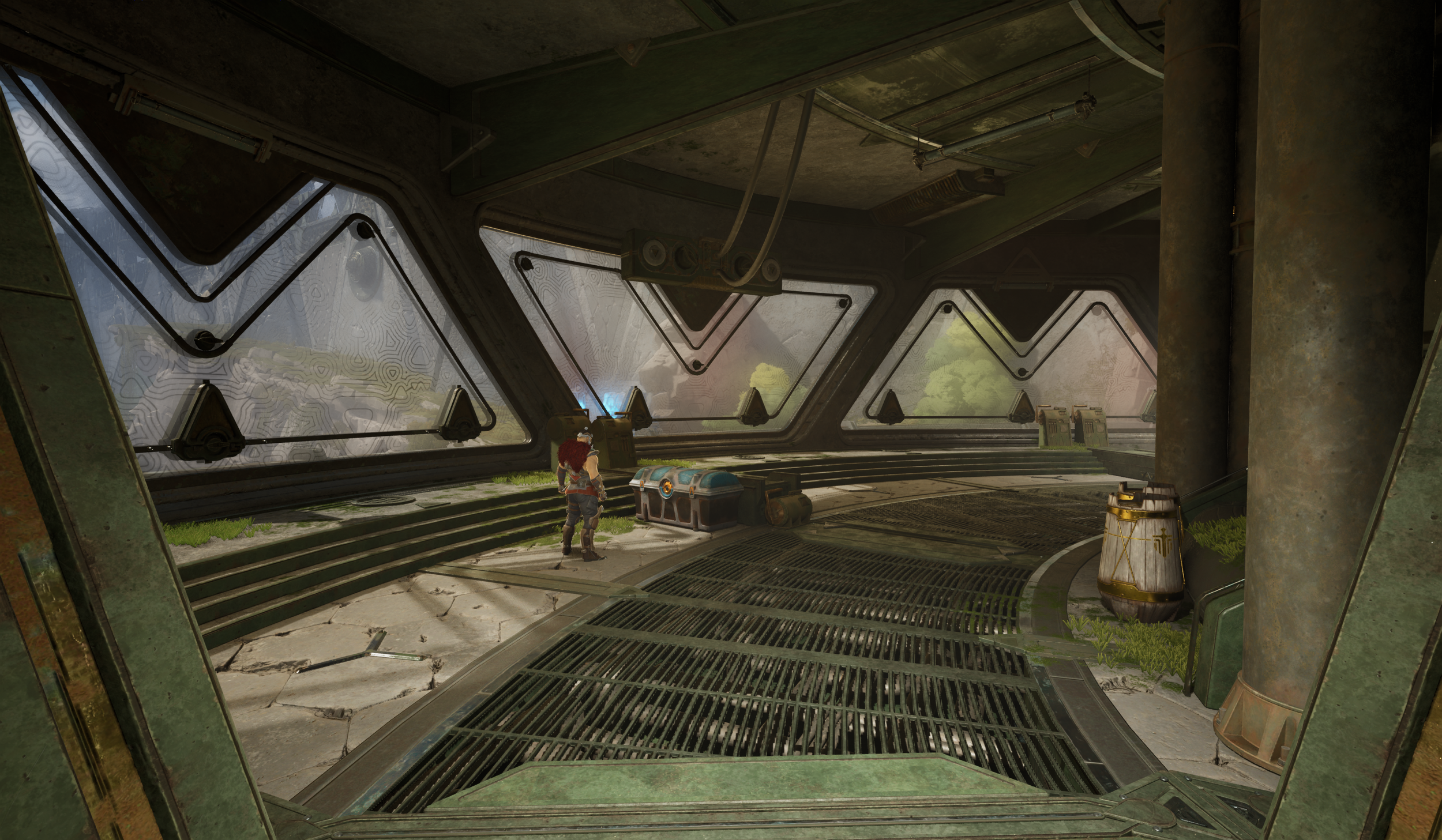 A futuristic interior with large, angular windows showing a lush green landscape outside. There is a person with white hair and a red outfit standing next to a small control panel and storage chest, with cracked flooring and some grass growing throug