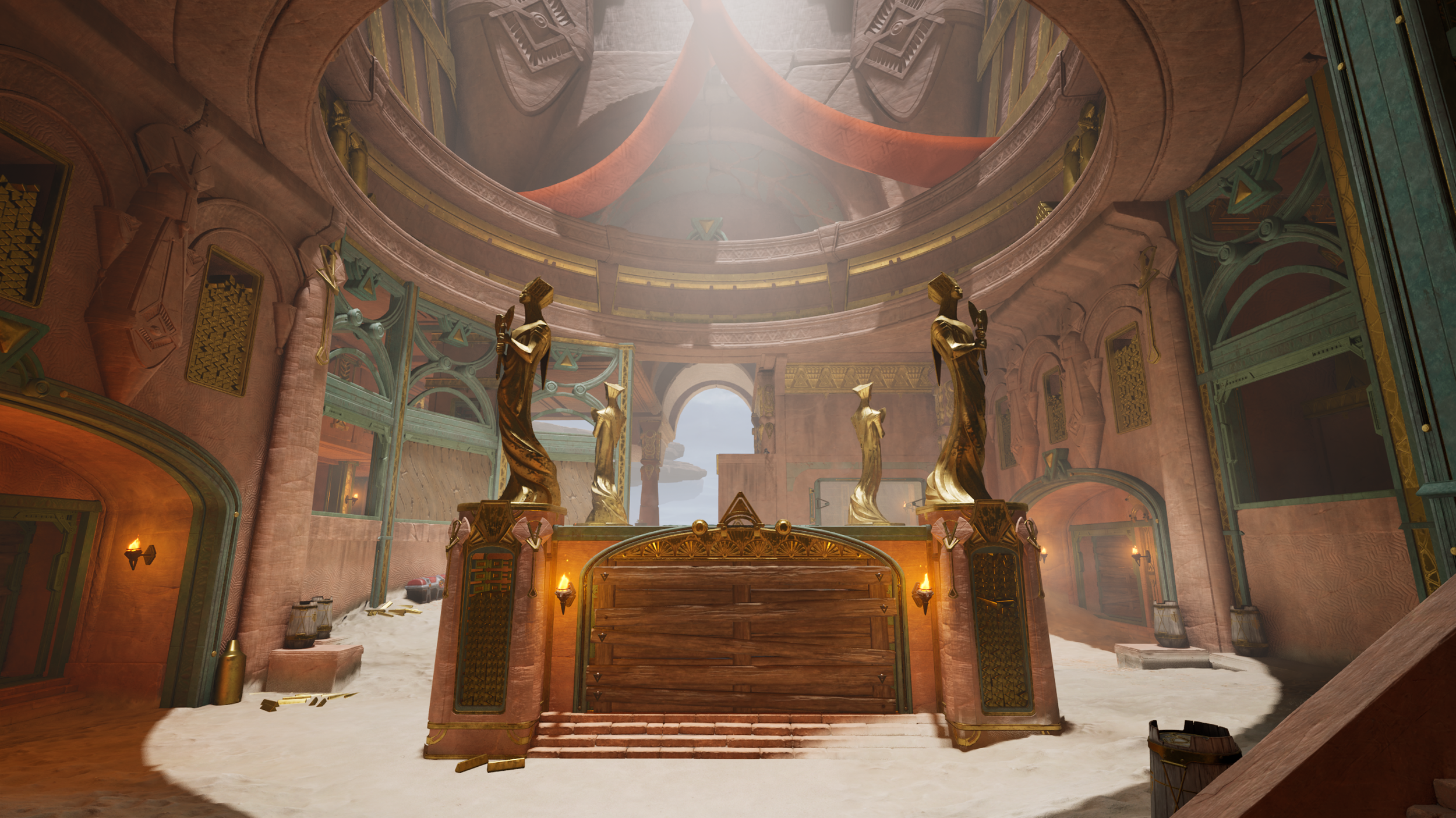 Interior of a grand arena with golden statues and ornate architecture, sandy ground, and sunlight streaming in from above.