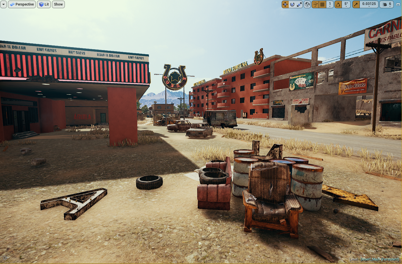 Abandoned lot with old furniture and tires, in front of a deserted motel and dilapidated buildings in a desert town.