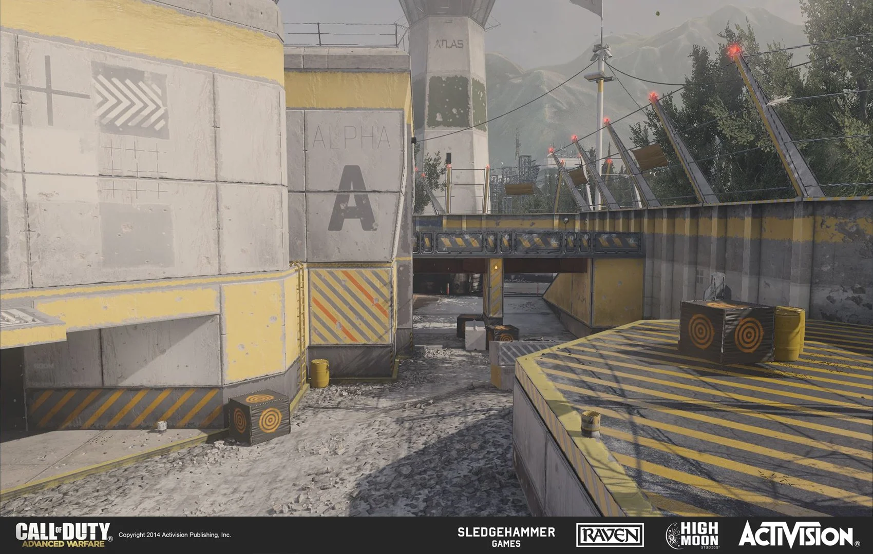 A virtual in-game scene from Call of Duty: Advanced Warfare showing a military-style outdoor area with concrete walls painted yellow and gray, several target boxes, barbed wire, and landscape with trees and mountains in the background.