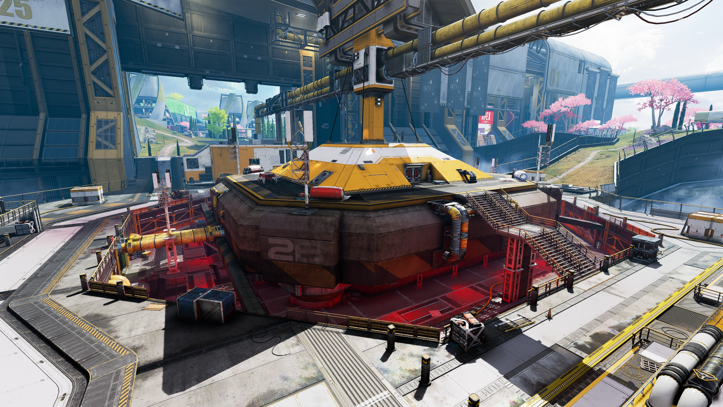 A futuristic military or industrial base with a large yellow and brown structure in the center, surrounded by various stairs, pipes, and equipment. In the background, there are pink cherry blossom trees, green trees, and a modern cityscape with advan