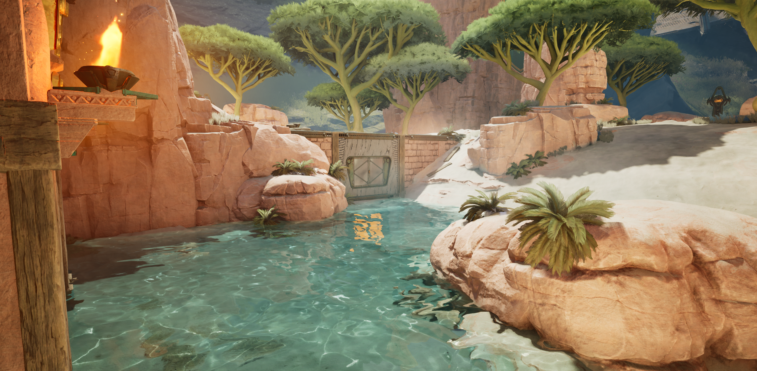 Digital illustration of a desert landscape with a small water body, surrounded by rocks and sparse vegetation including bushes and small trees, with a rocky wall and a fire feature in the background.