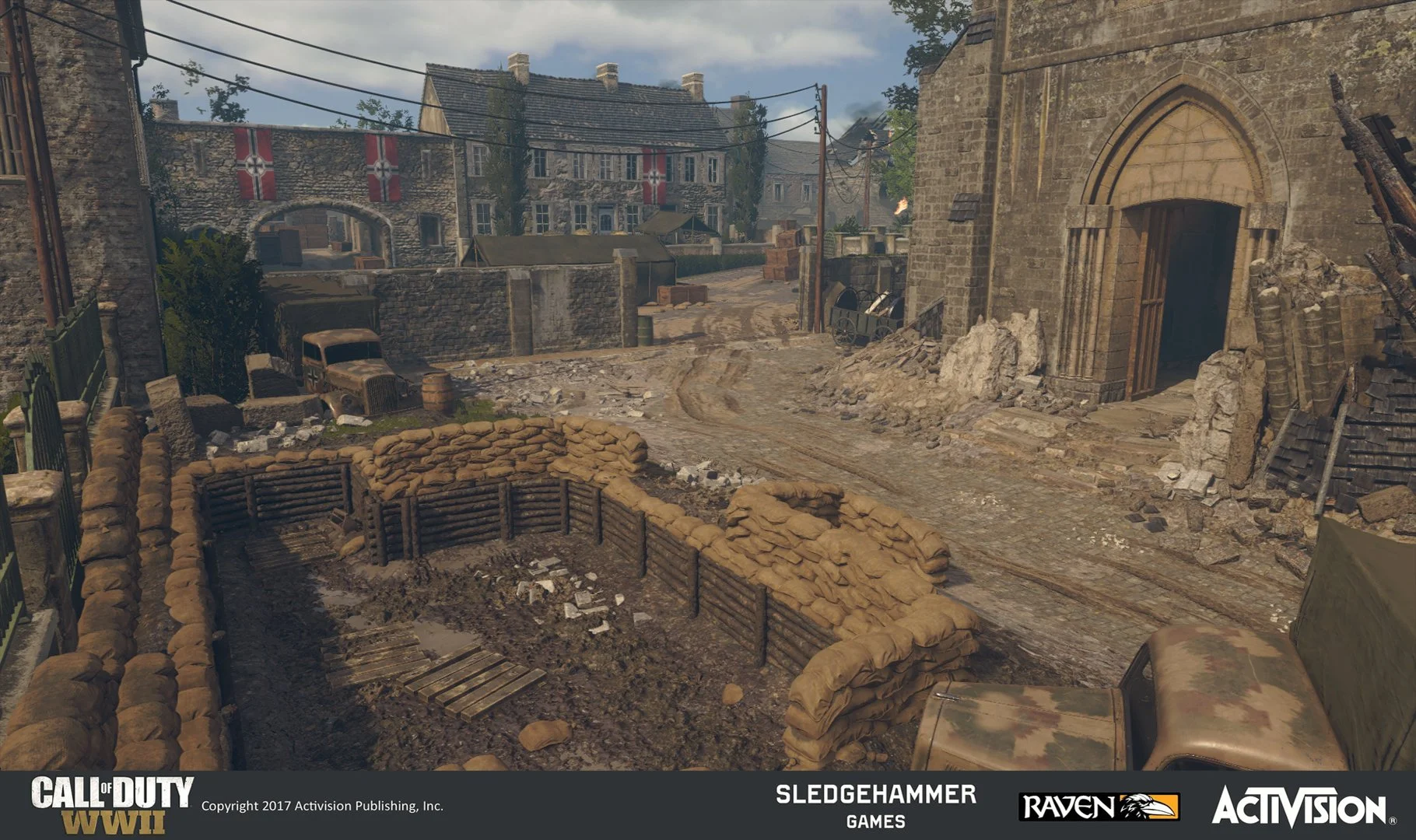 A wartime street scene from Call of Duty WWII featuring a trench with sandbags, a muddy road, damaged buildings, a military vehicle, and a background of houses decorated with flags