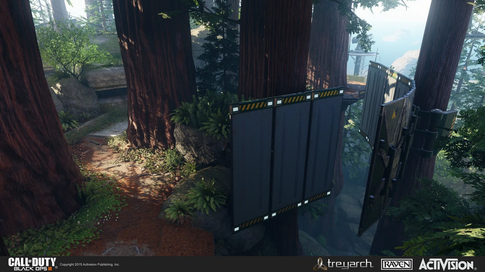 A forest with massive trees and a narrow pathway, showing a high platform with black retractable barriers and warning stripes.