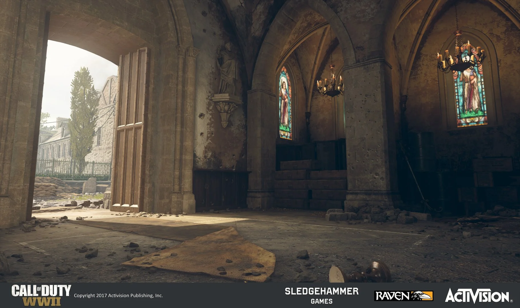 Interior of a damaged, abandoned church with stained glass windows and debris on the floor, including a fallen table and scattered rocks.