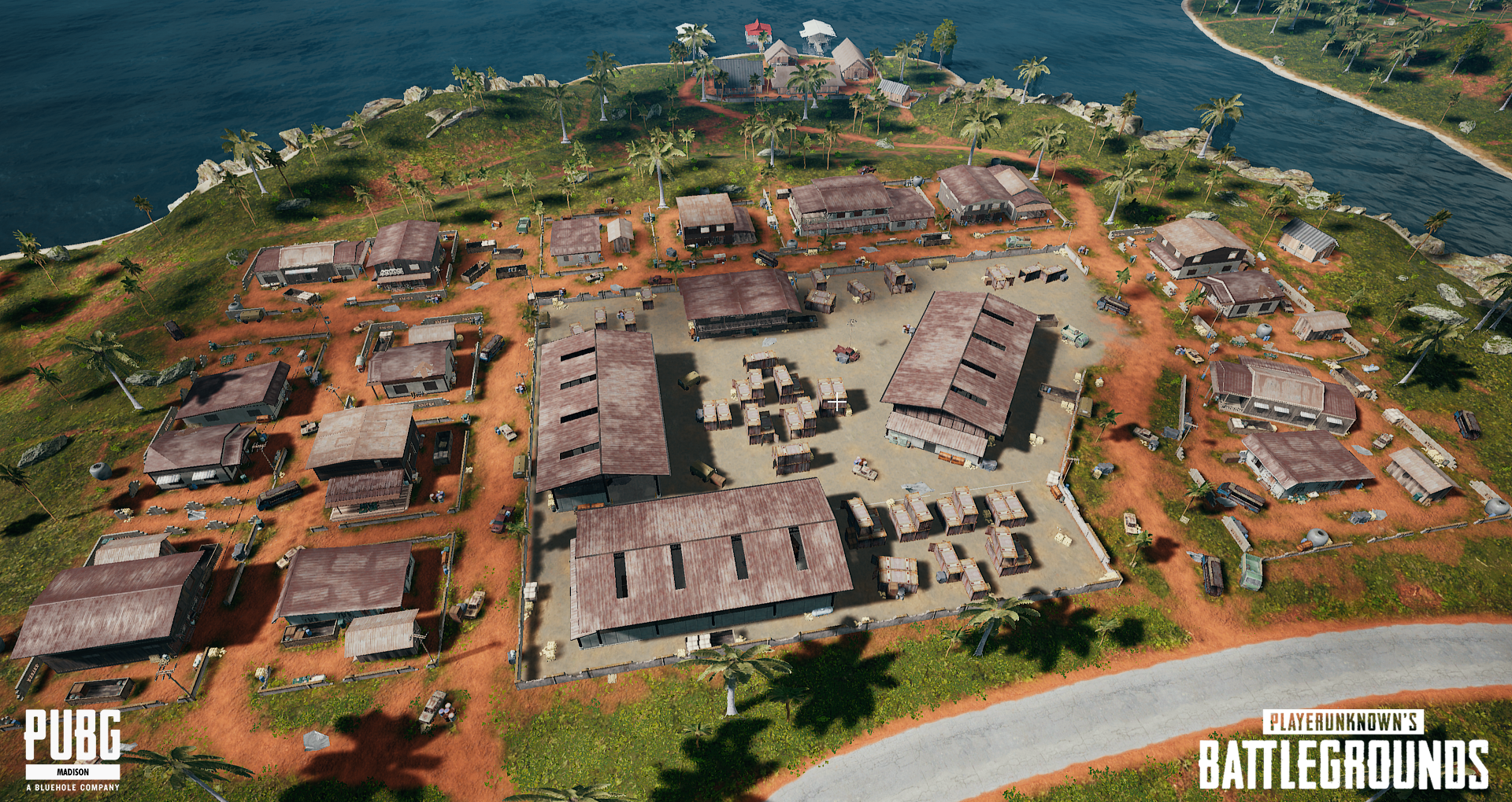 Aerial view of a gaming map from PUBG: Battlegrounds set on an island with buildings, roads, trees, and water surrounding it.