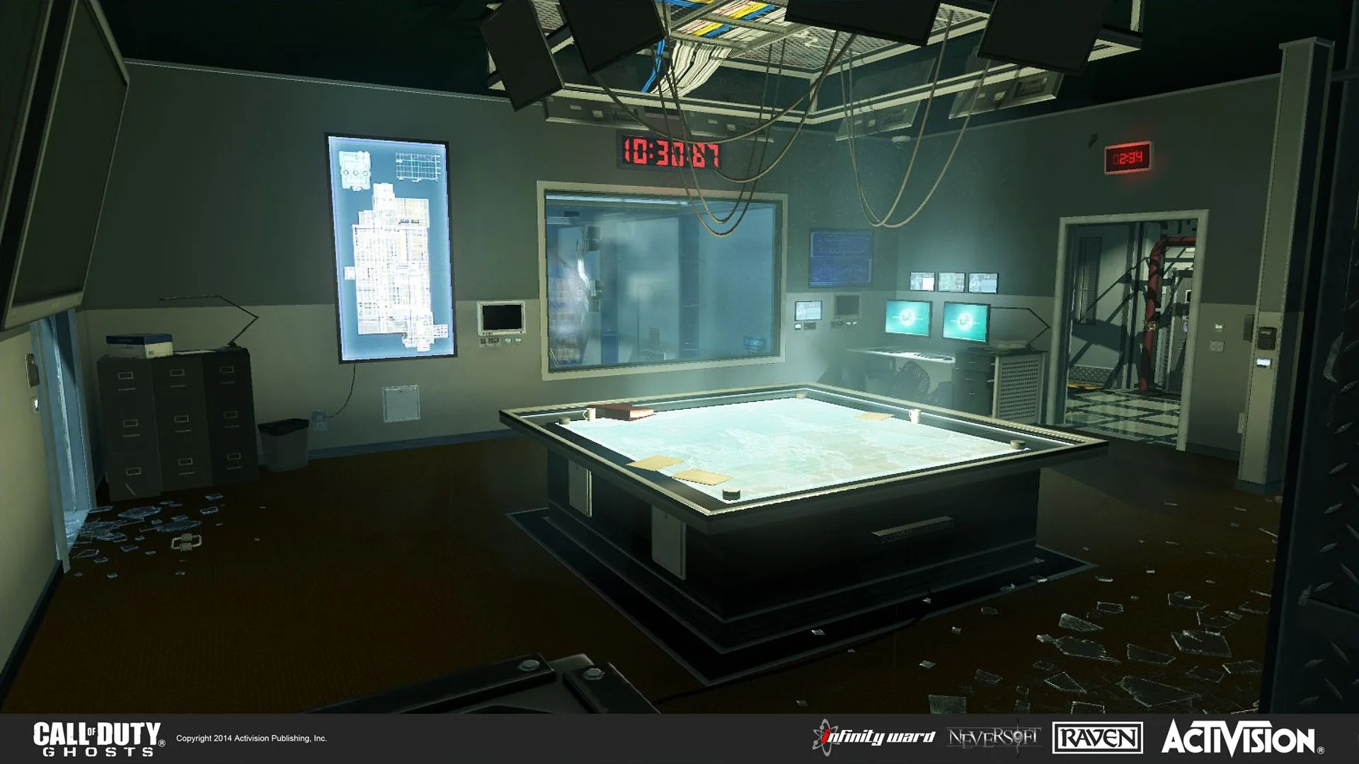 A control room with a large digital map table in the center, multiple monitors on the ceiling and walls, and broken glass on the floor.