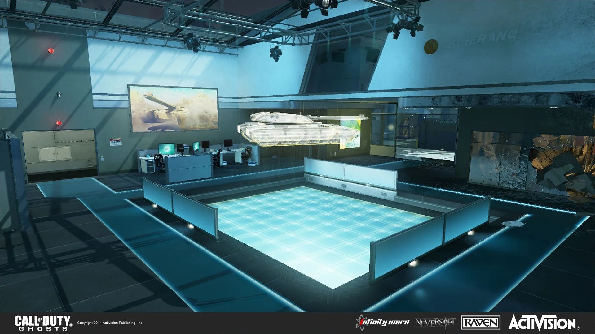 A futuristic room with glowing blue floor and walls, featuring a holographic tank in the center. Multiple computer stations and large screens are mounted on the walls, and there are structural metal beams and lighting fixtures overhead. The room has 