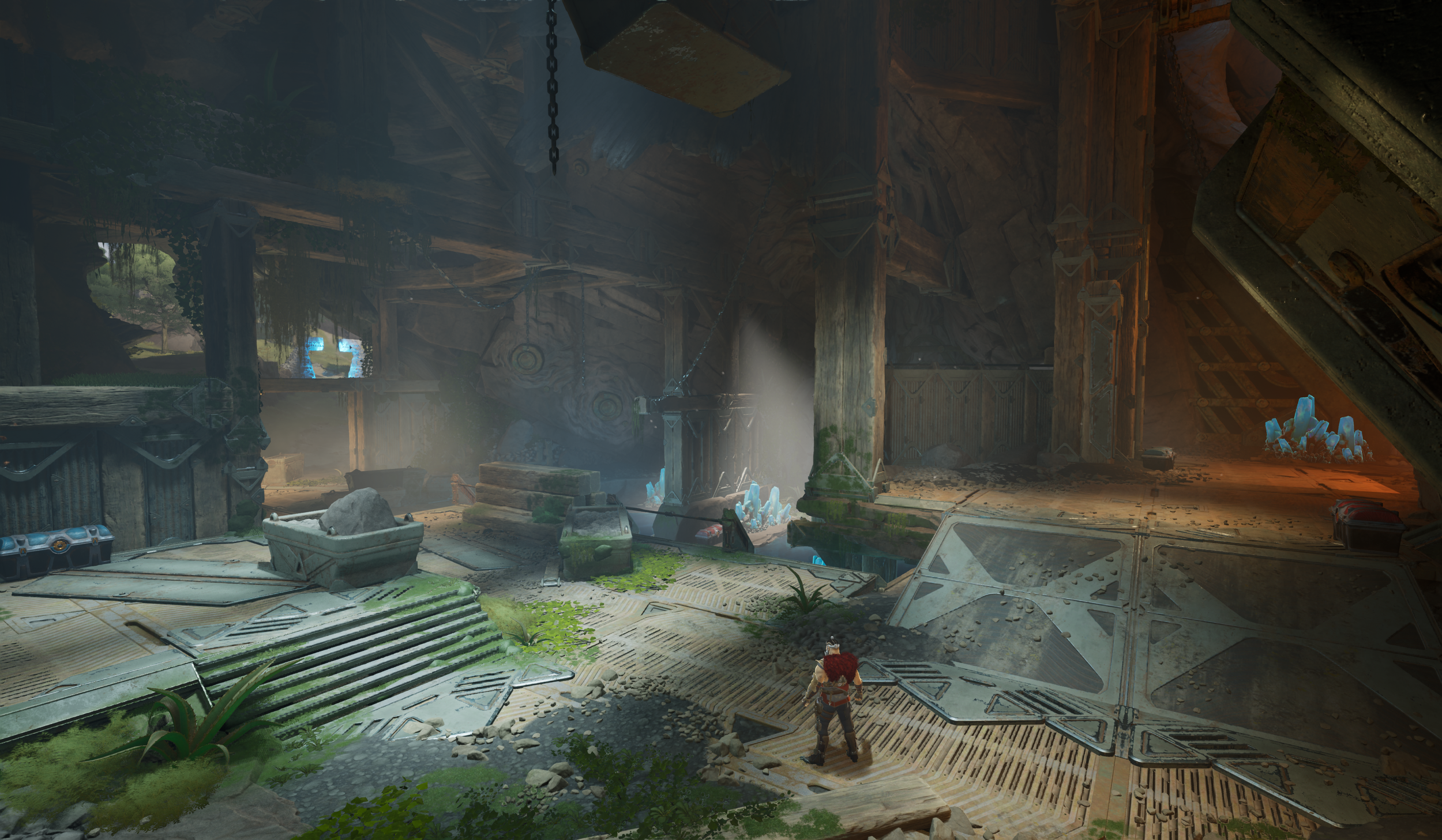 A video game scene showing a character standing in a rocky cave-like environment with greenery, stone stairs, and glowing blue crystals.