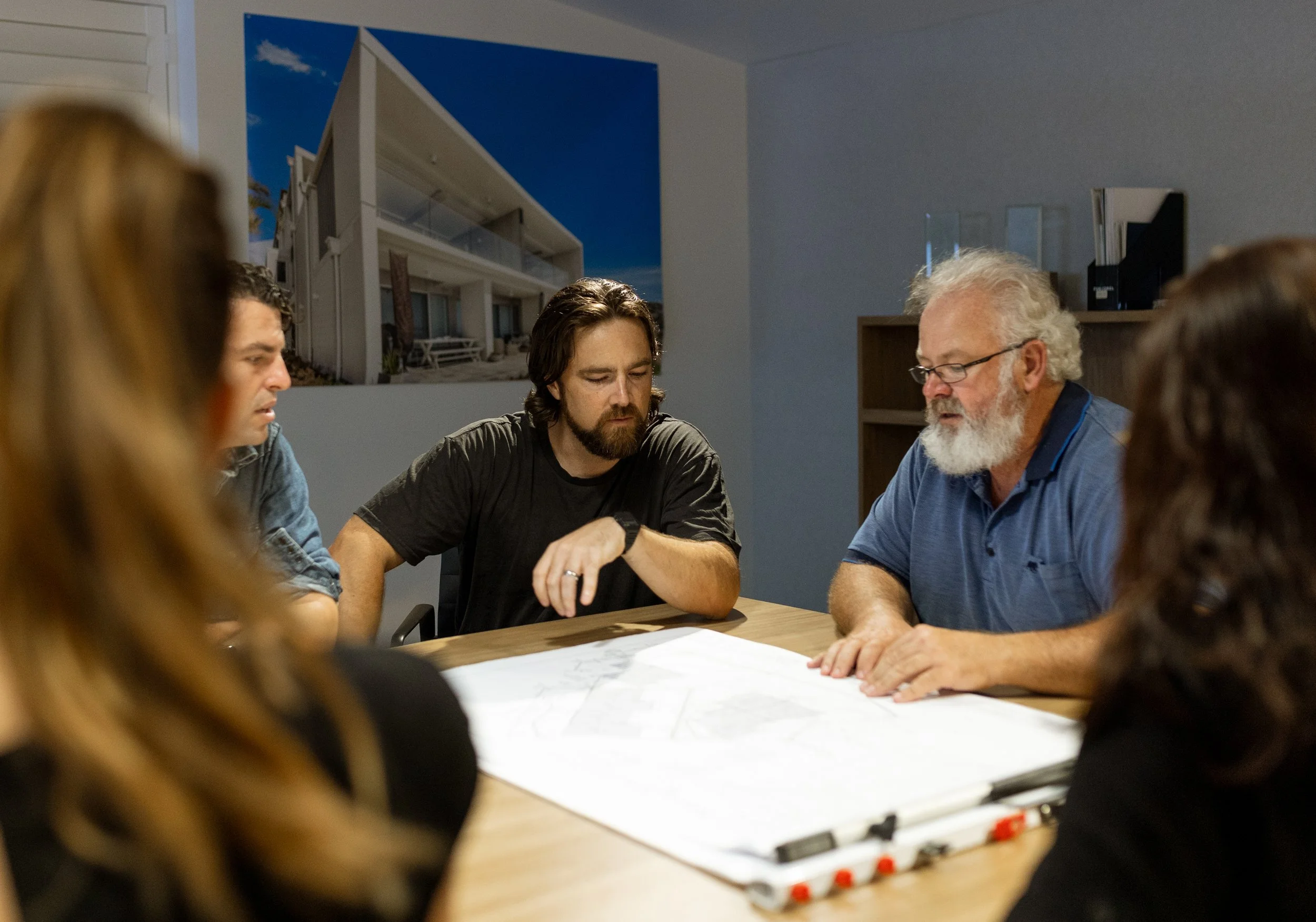 An accountant meeting with a property developer about his growing business and its future.