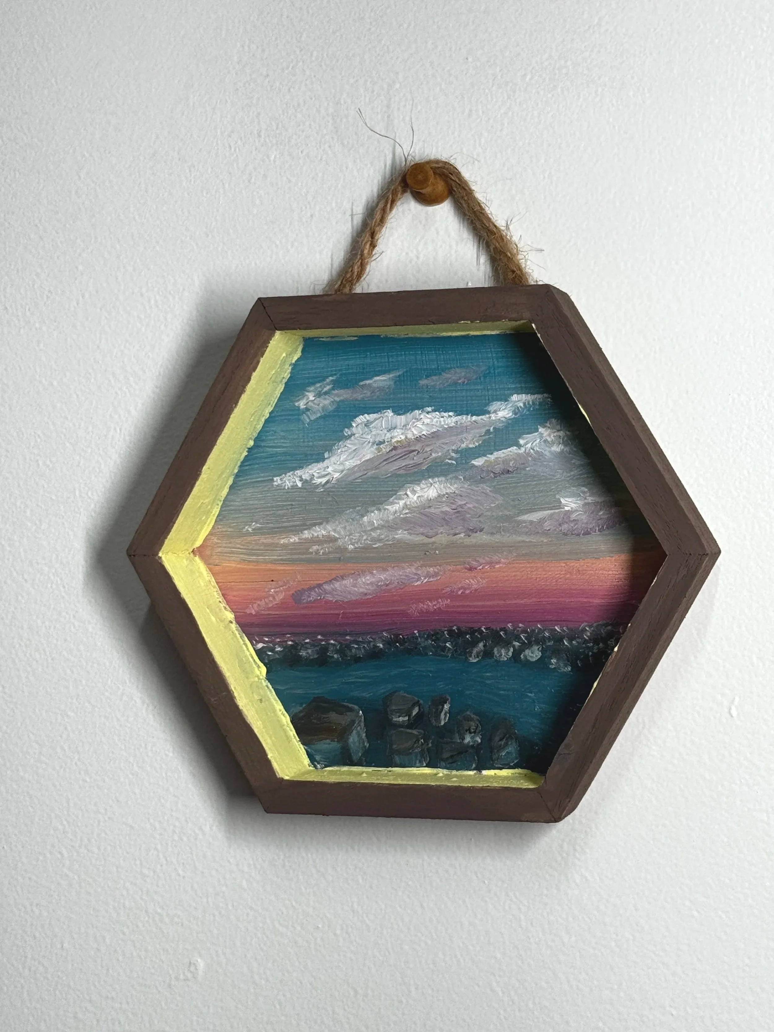 "Signal Breakwater" 5 inches x 5 inches, Oil on wood, 2025 The horizon flickers with the hush of static, where concrete geometry interrupts the ocean’s code. This view holds both peace and interference — a manufactured lull in the signal. The sky, so