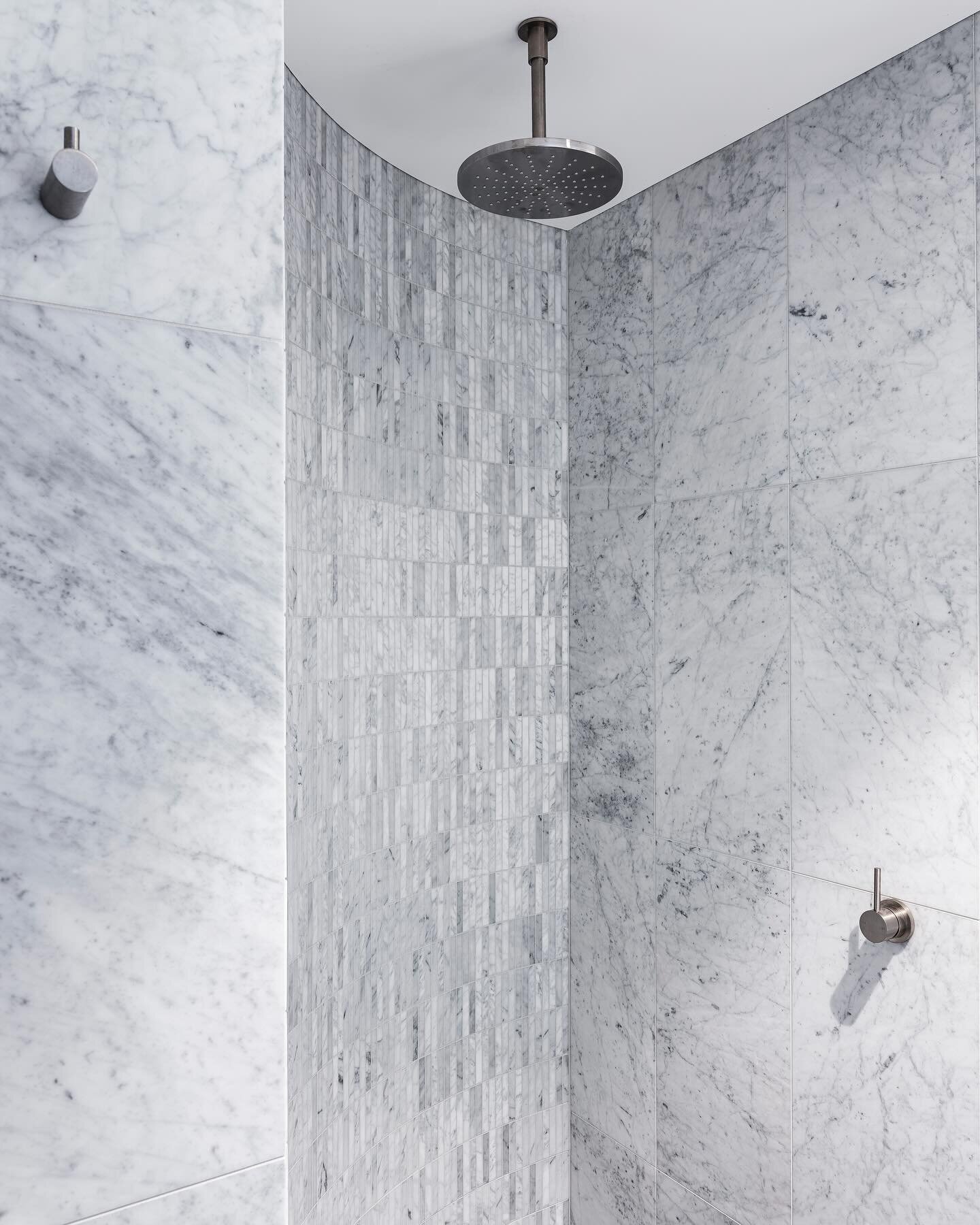 TALOOMBI &bull; A curved shower wall allowed us to make a subtle statement with mosaic cararra marble tiles #InnovateInteriors