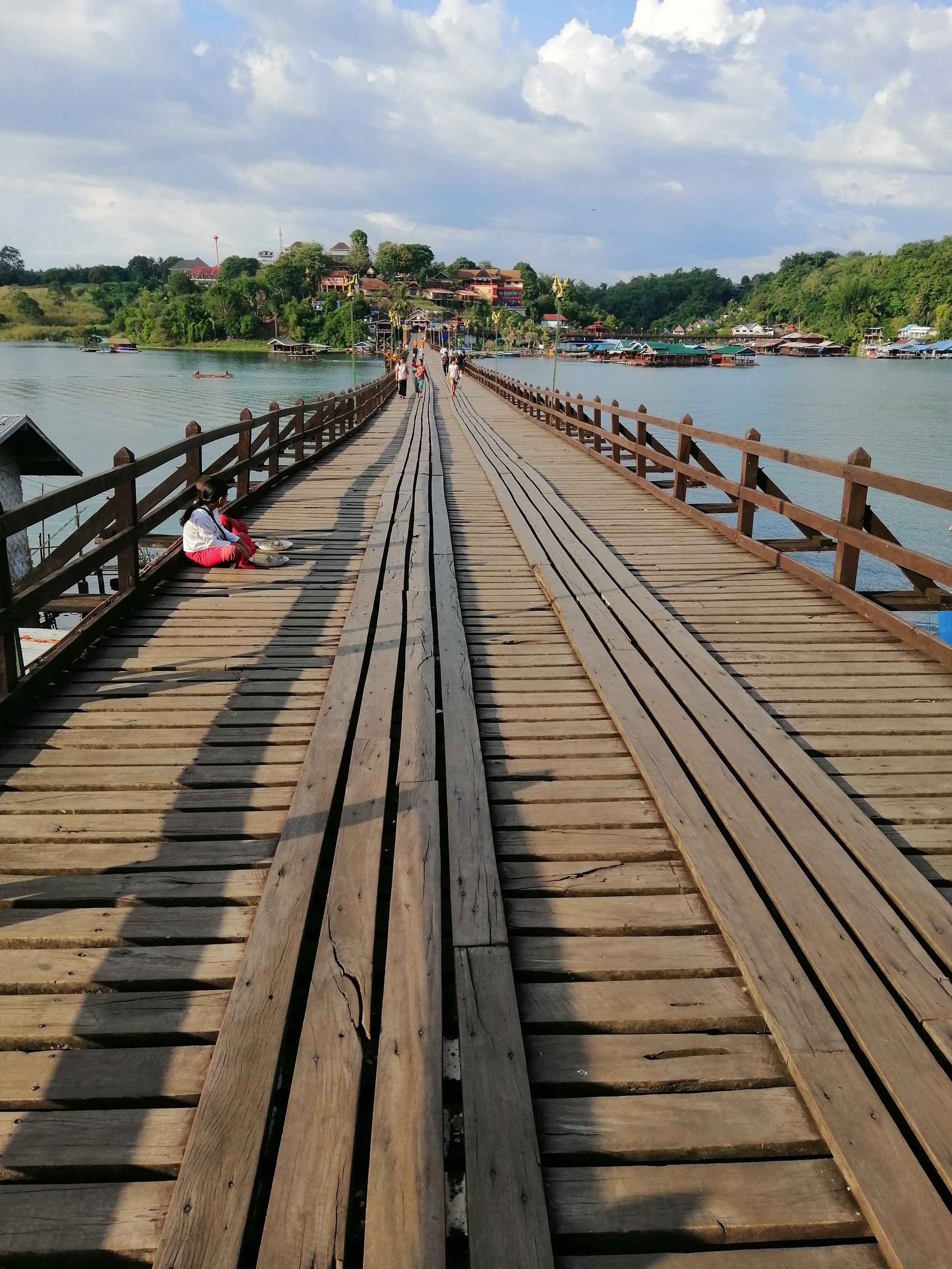 Uttamanusorn Bridge, also known as the Mon Bridge, located in Sangkhla Buri, Kanchanaburi, Thailand. The Mon Bridge (Uttamanusorn Bridge): Built in 1986–1987, this 850-meter wooden bridge was constructed by the local Mon community, connecting Wangka 
