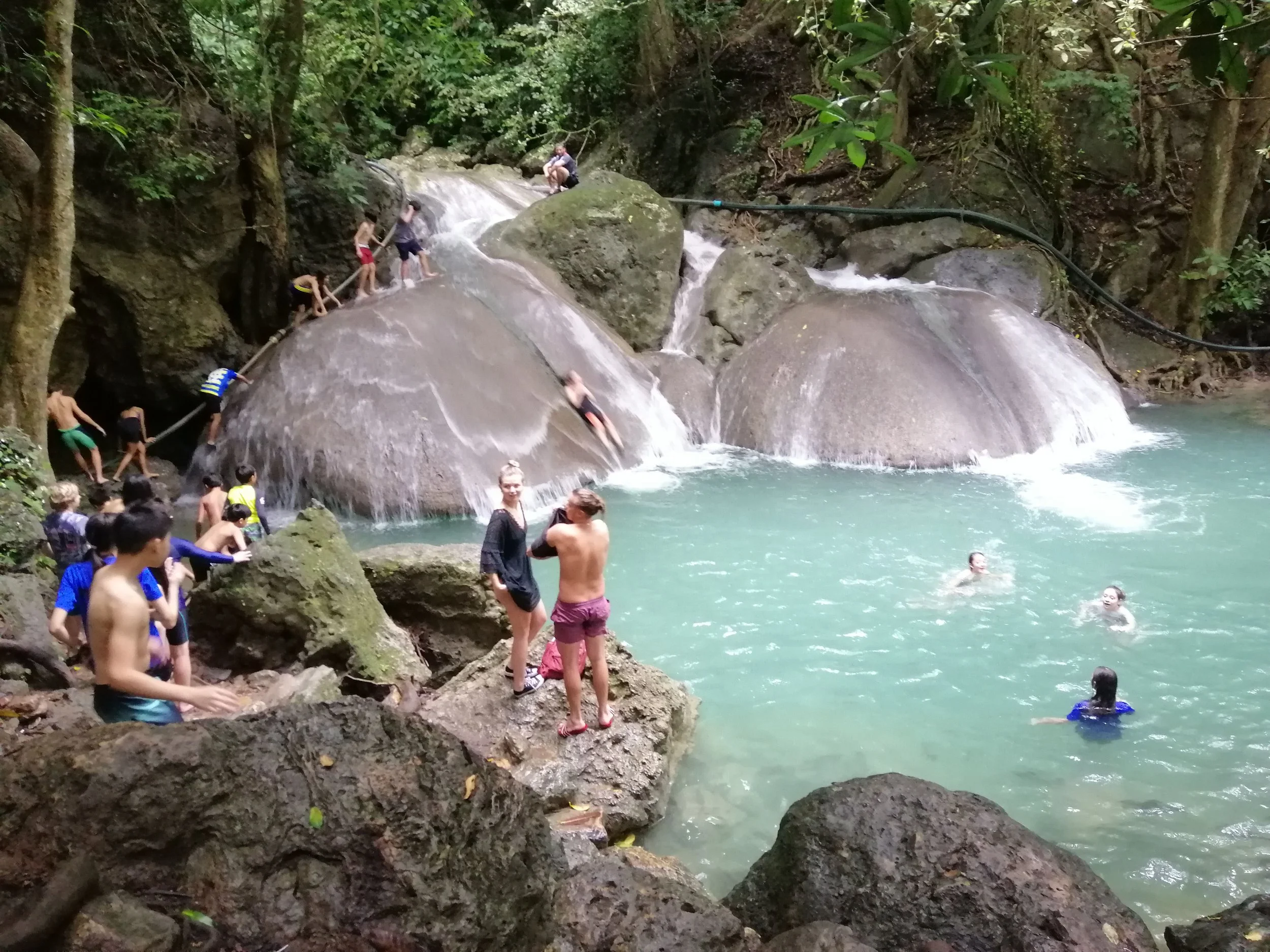 Tourists swiming in the turquoise pools of Erawan NP.