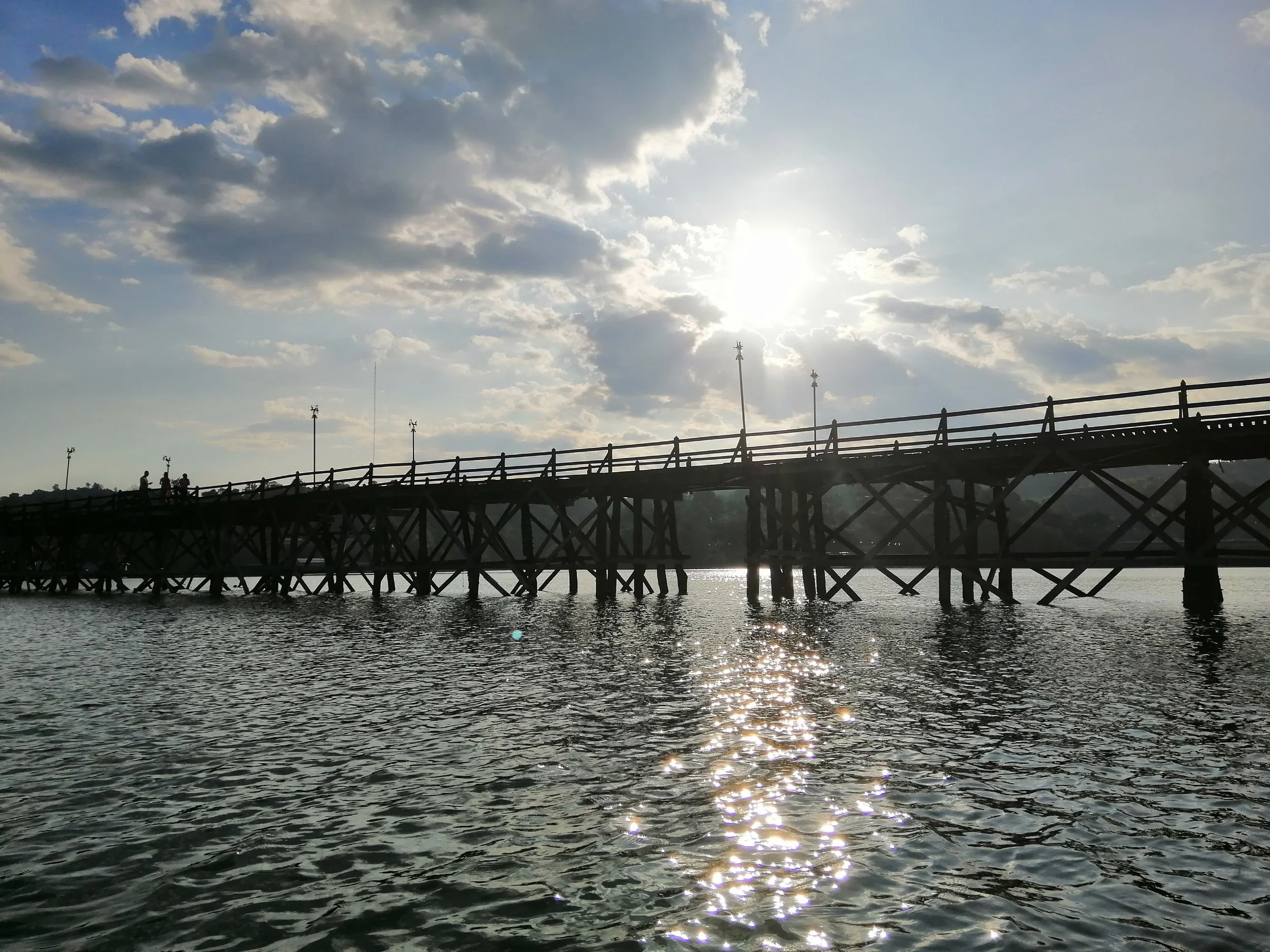 Uttamanusorn Bridge, also known as the Mon Bridge, located in Sangkhla Buri, Kanchanaburi, Thailand.  Mon people have lived in Kanchanaburi for centuries, the specific community in Sangkhlaburi's Wangka Village is roughly 70–80 years old, growing thr