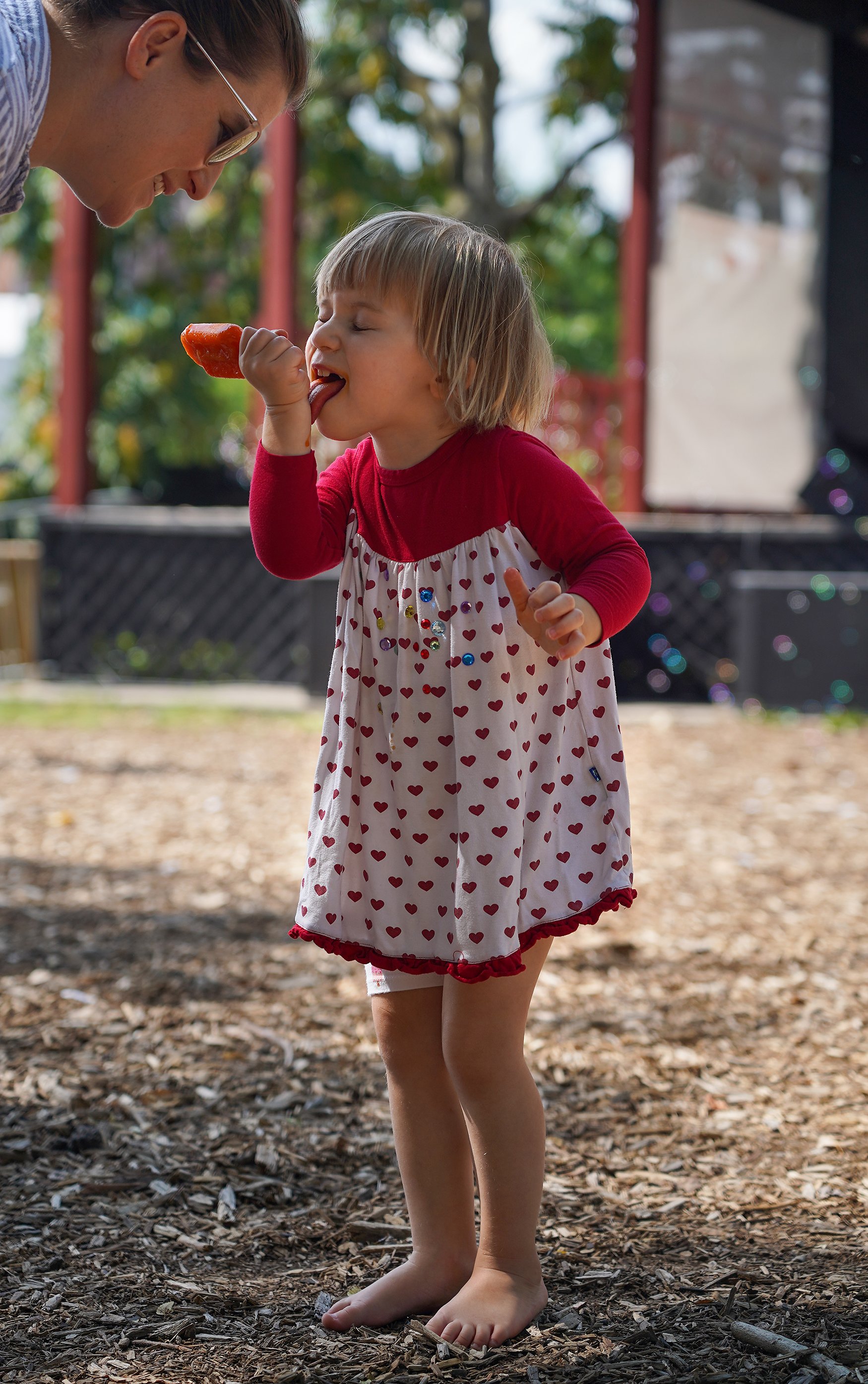 Nora Caldwell, 2, licks her melting popsicle off of her hand while her mom, Maggie Cauffman, asks if she needs a napkin July 9 at Rose Music Hall. While kids enjoyed popsicles, parents stopped by the bar inside for a refreshing pint of beer.