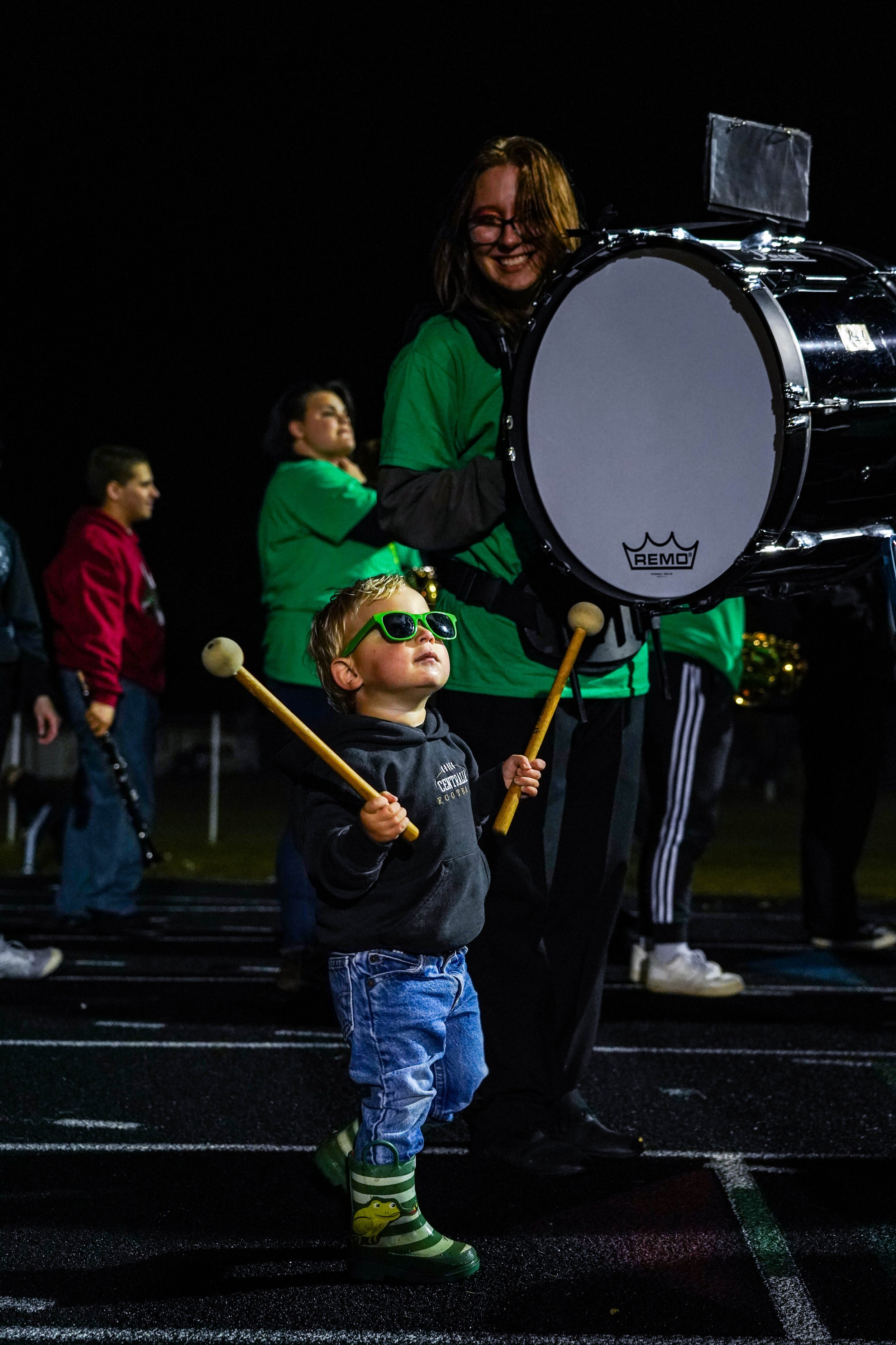 Augie Thall, 2, steals the mallets from a Centralia marching band student on Sept. 23 in Centralia. Thall watched the band perform its halftime show after being chased by his mom to return the mallets.