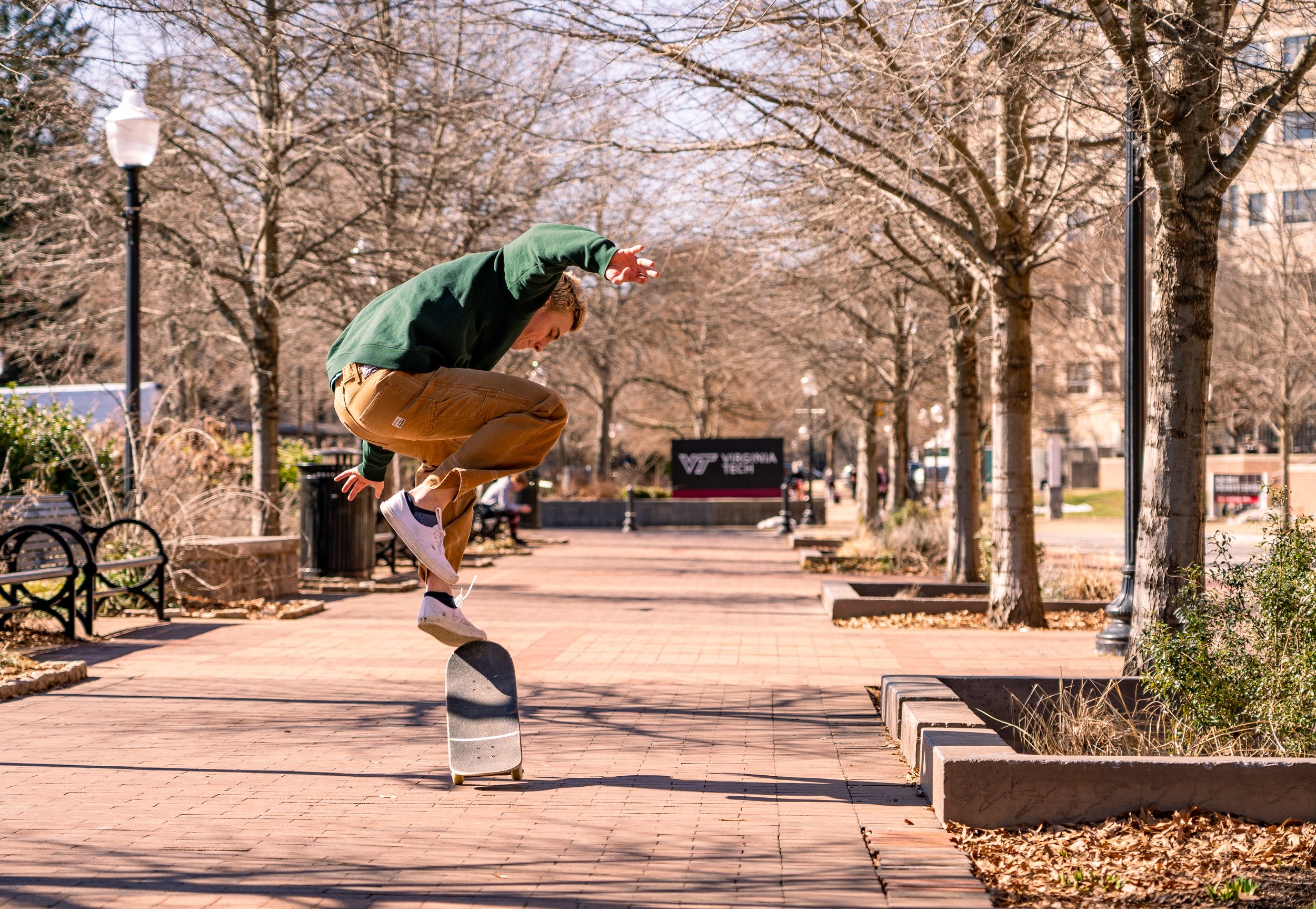 Alex, a student at Virginia Tech, skateboards near Newman Library between classes. Skateboarding on campus has been a point of contention in the place with the University attempting to ban it in certain locations.