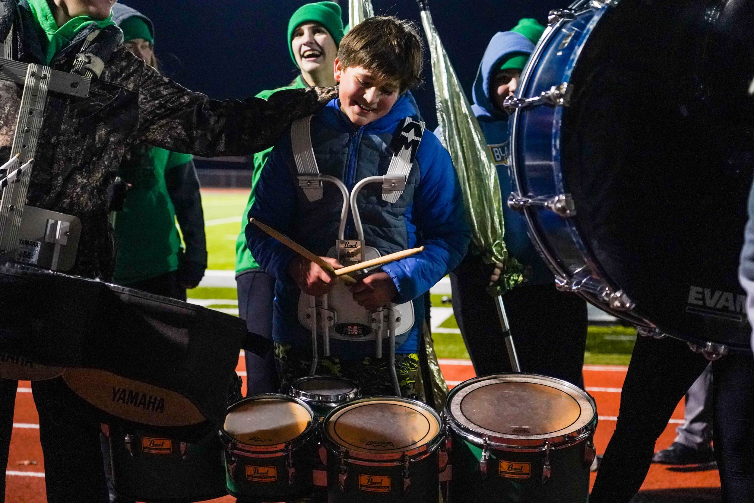 Liam Koester, 12, is congratulated by fellow Blair Oaks High School band members following a solo performance during half-time Nov. 11 in Wardsville. “It was pretty intense playing tonight, but all my friends were cheering me on,” Koester said.