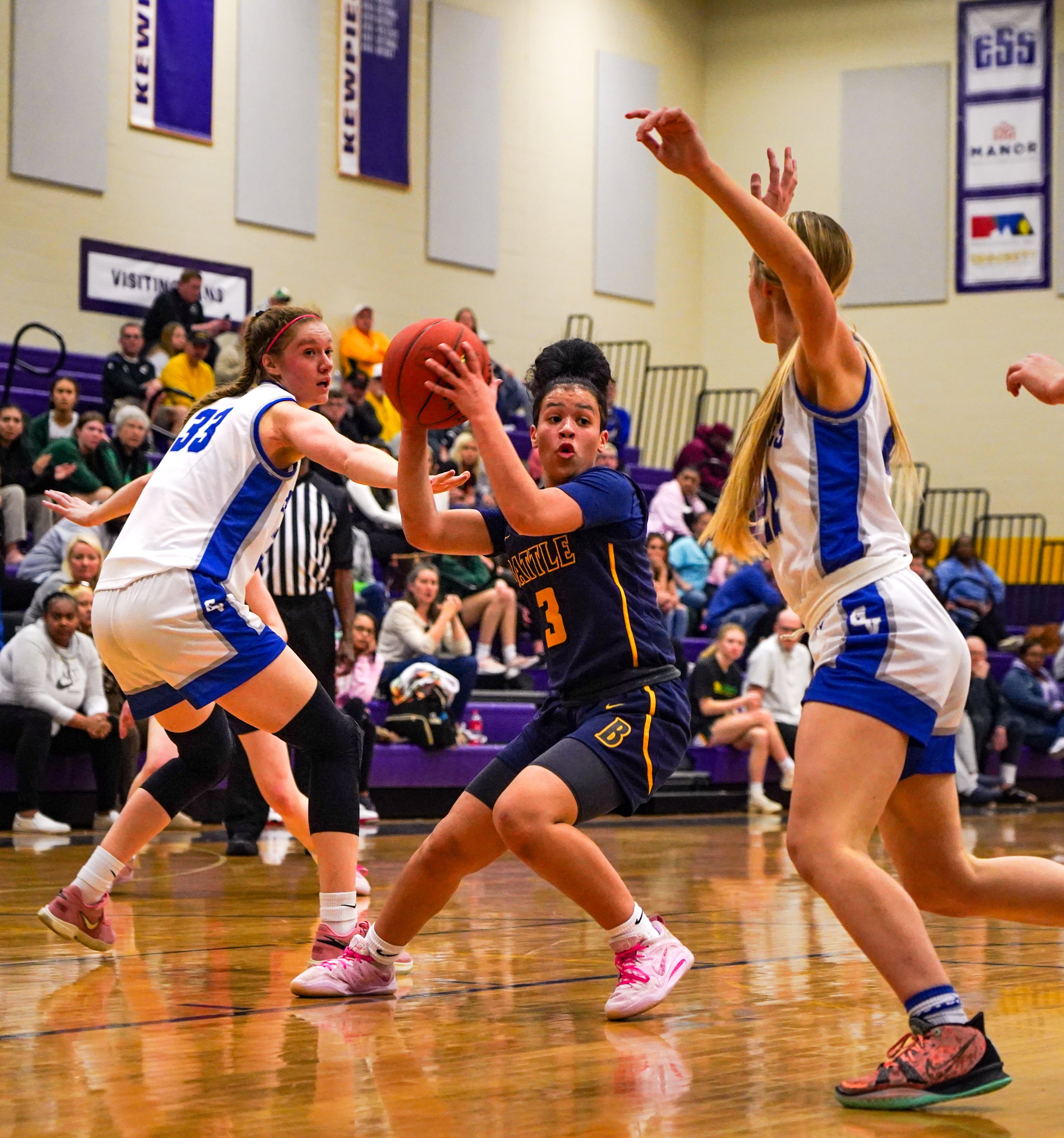 Attempting to come from behind, Battle point guard Tayla Robinson (3) blows by two Grain Valley defenders on her way to the basket. Robinson held her own against a generally taller Grain Valley team and ended the game with 15 points.