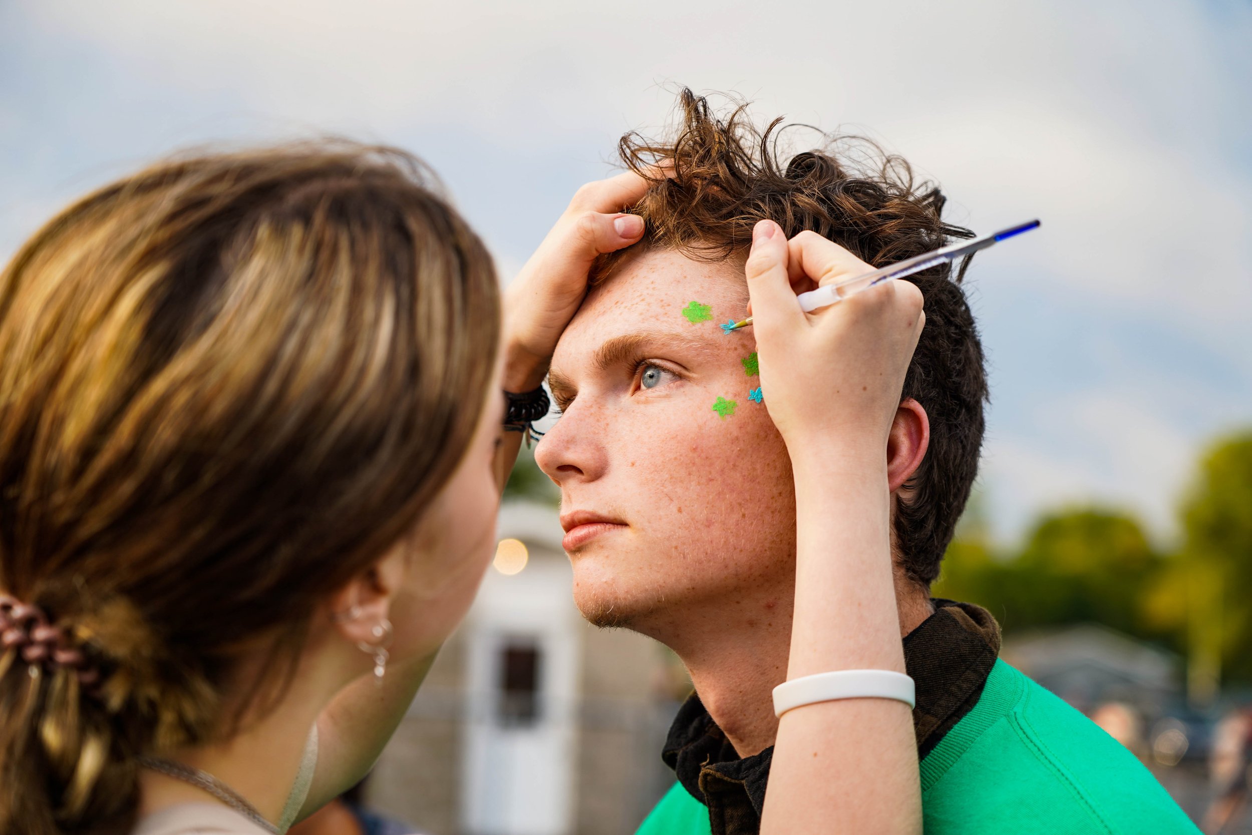 Centralia sophomore Lily Colwell paints Elijah Hill’s face before the Panthers’ game against Monroe City on Sept. 23 in Centralia. Hill played in the marching band at halftime.