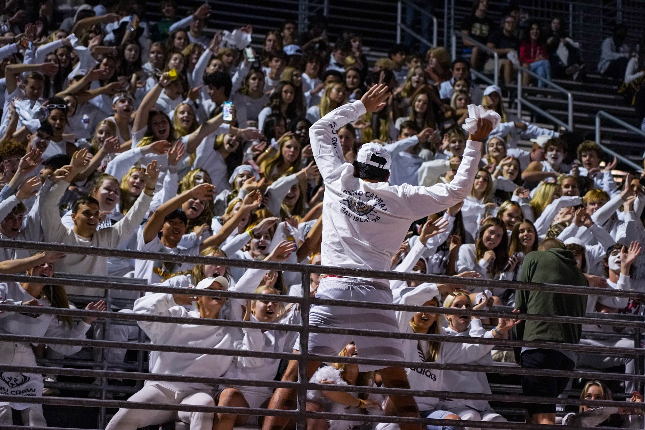 The Rock Bridge High School student section does the wave Sept. 30 in Columbia. The seniors led their classmates all night long in chants, routines and traditions to support the football team.