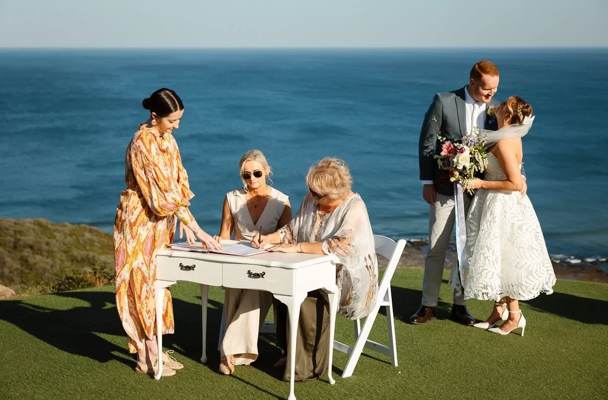 Almost one year ago, India and Rowan tied the knot in this breathtaking clifftop ceremony &mdash; complete with sunshine, ocean views, and so much love. 🌊💍

It was such a joy to officiate their special moment as Sweet Basil Celebrant, with both mum