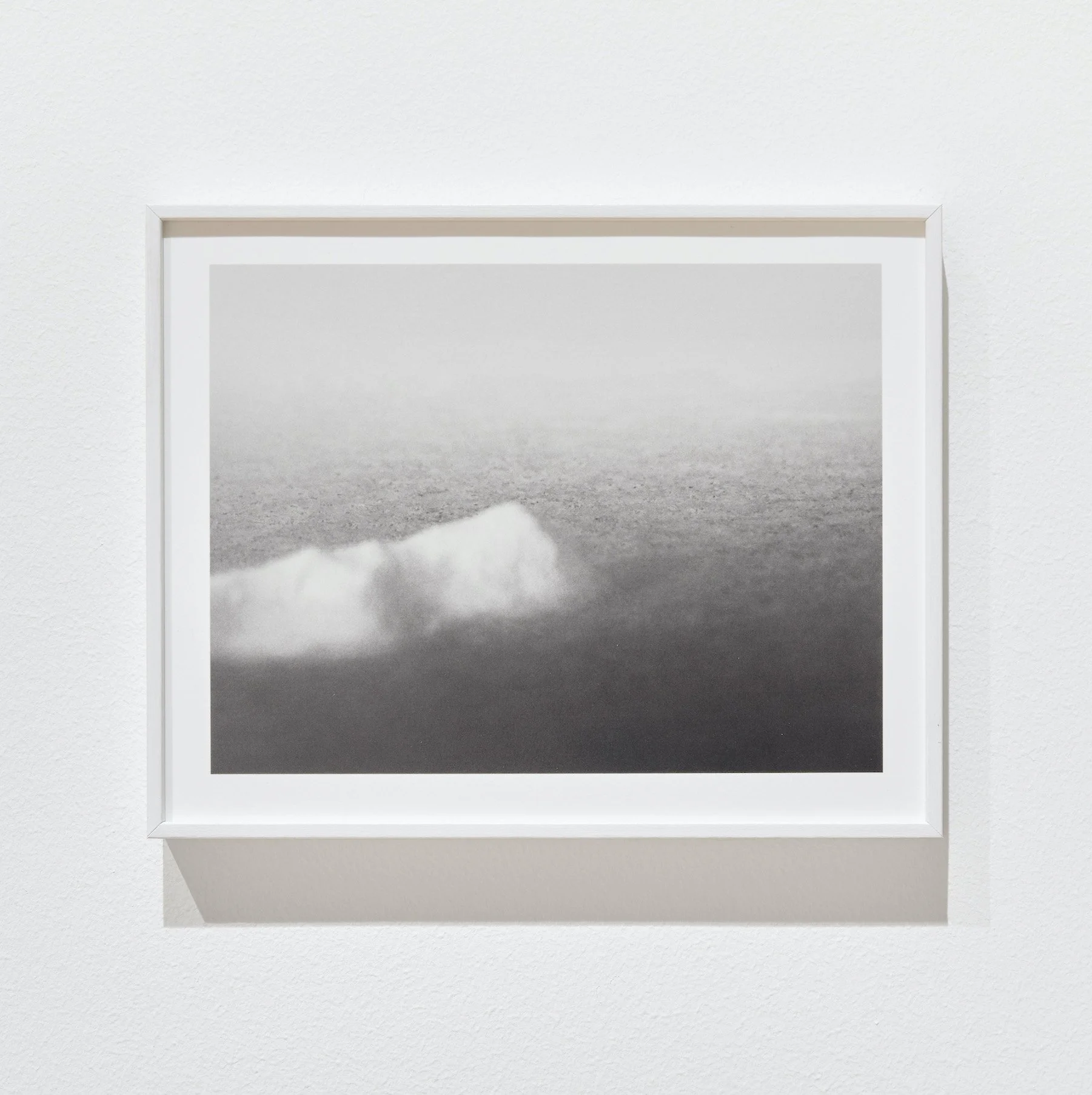 Black-and-white photograph by Nils Olav Bøe, describes a mountain in a landscape