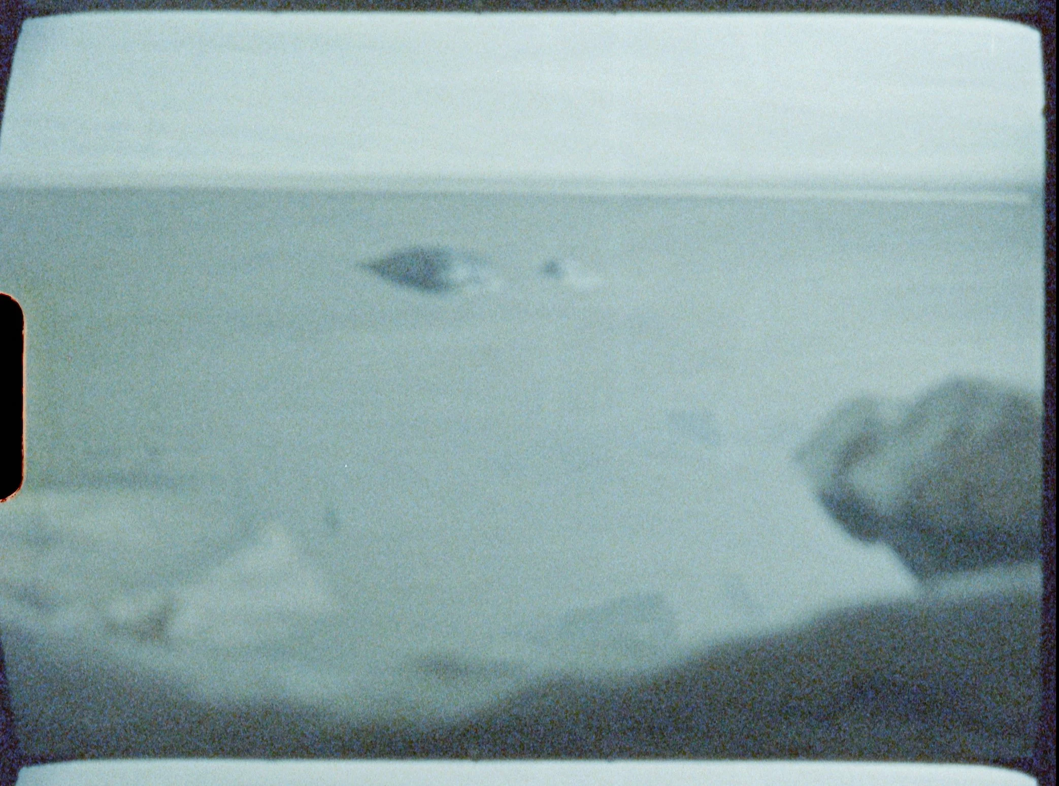 Nils Olav Bøe / Boe, film still from a Super 8mm film, depicting a foggy architectural landscape.