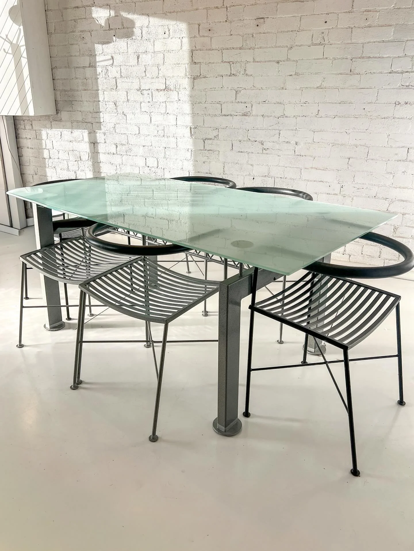 Available- 90's early 2000's dining set by Aero designs of Melbourne.

Frosted glass top with industrial truss style legs in a grey hammer tone finish. 

6 chairs- 4 in a hammer tone grey finish and 2 in black powder coat.

Super cool set! 

#aerodes