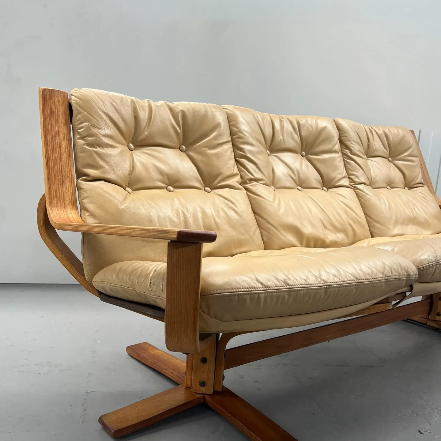 1970s leather three-seater by South Australian maker Joe Rufenacht.

Sculptural timber frame, original tan leather, and buttoned cushions &mdash; a classic Australian modernist lounge with vintage patina.

Leather cleaned and conditioned, frame clean