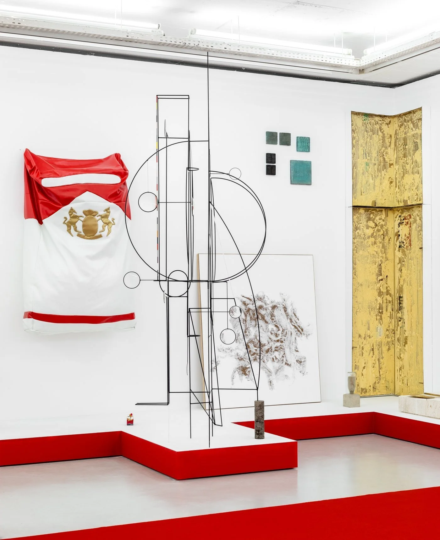  Carlos Bunga’s sculpture can be seen by the right corner, a cardboard and yellow paint wall referring to his architectural spaces and site-specifics. Courtesy: Cristina Guerra Contemporary Art.  