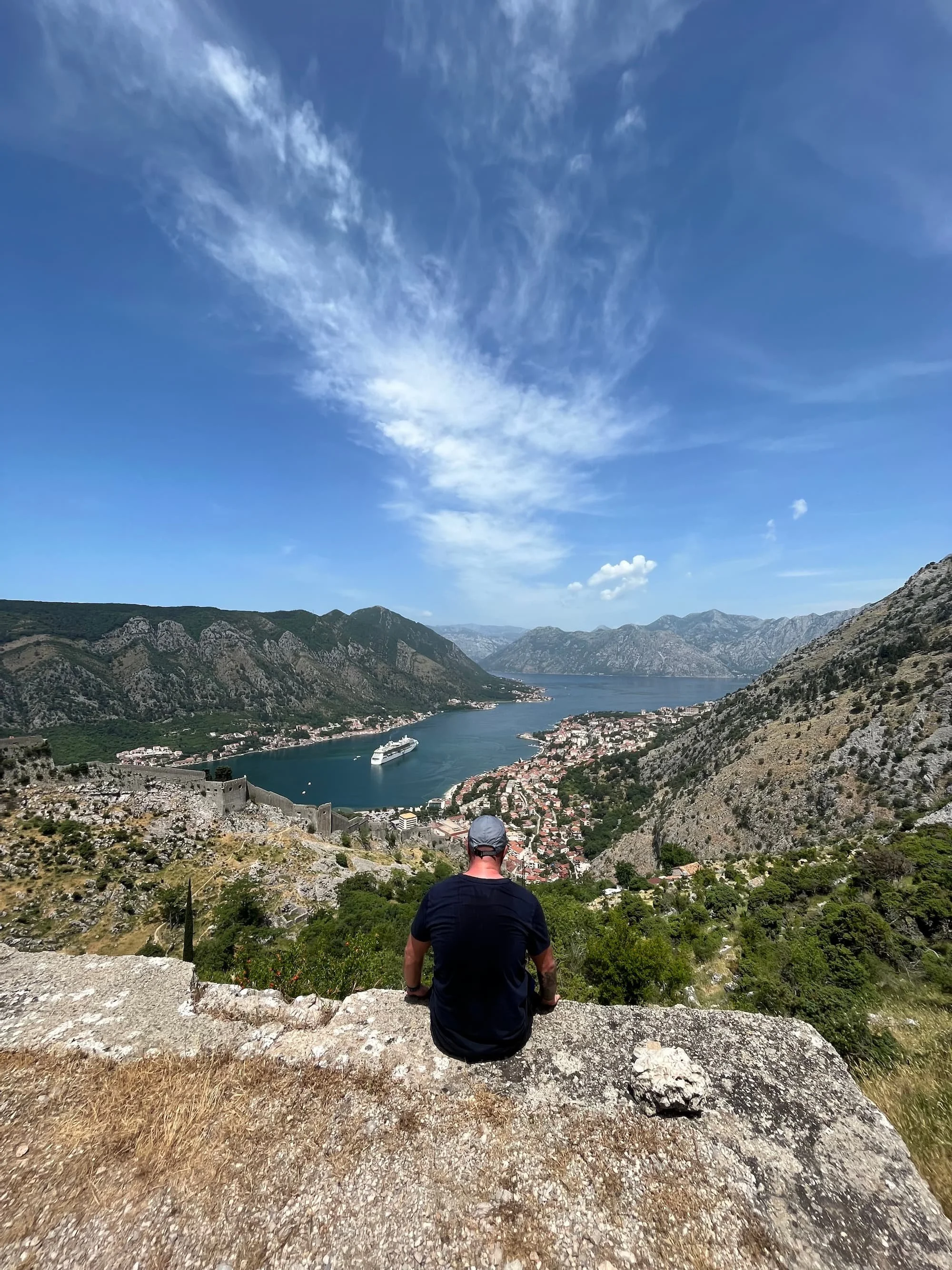 Tom Henty sat at Kotor Bay viewpoint overlooking the beautiful scenery