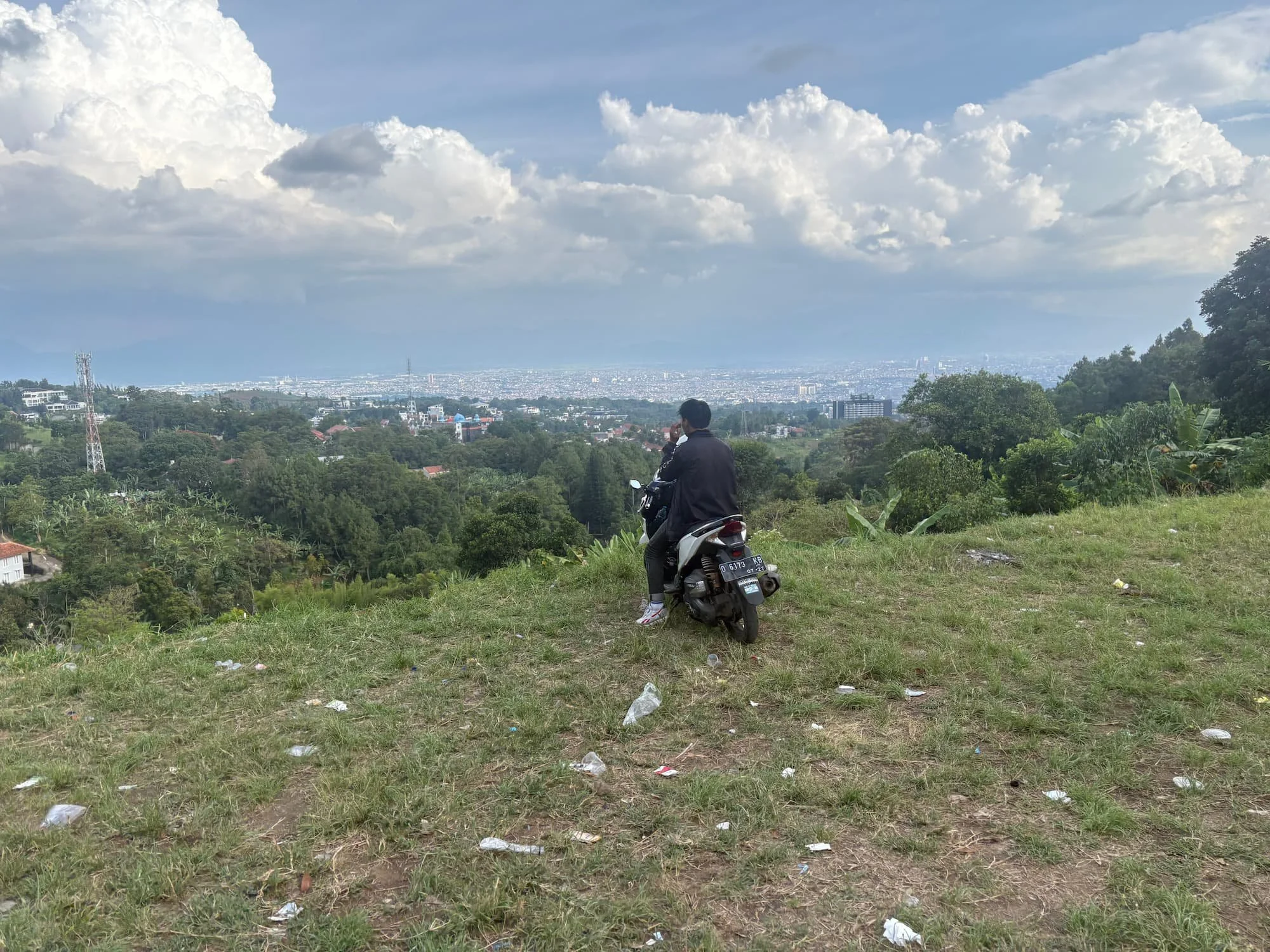 Bandung city viewpoint from hillside with scooter showing navigation and travel exploration using eSIM