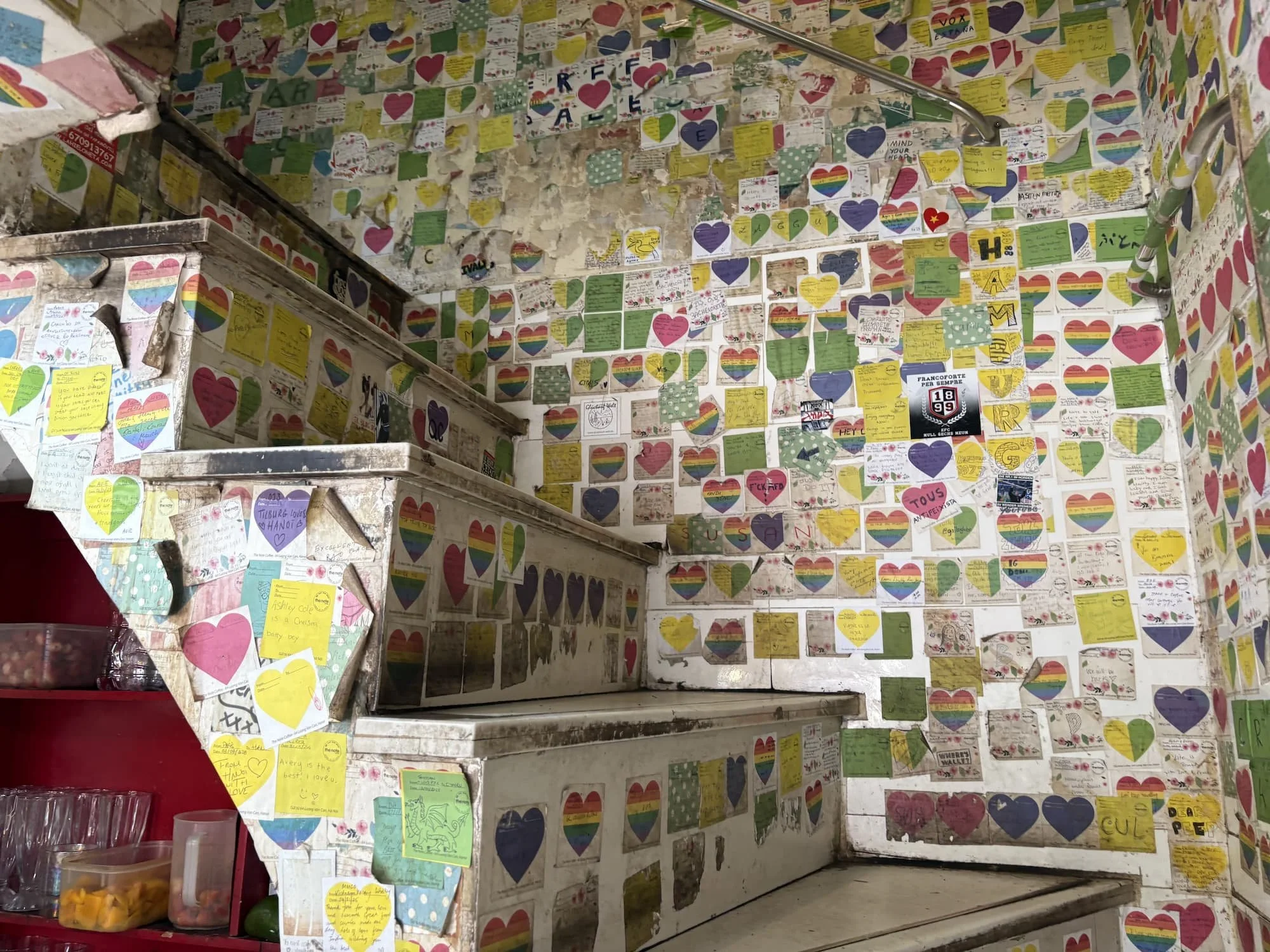 Staircase covered in stickers at The Note Coffee in Hanoi in Vietnam
