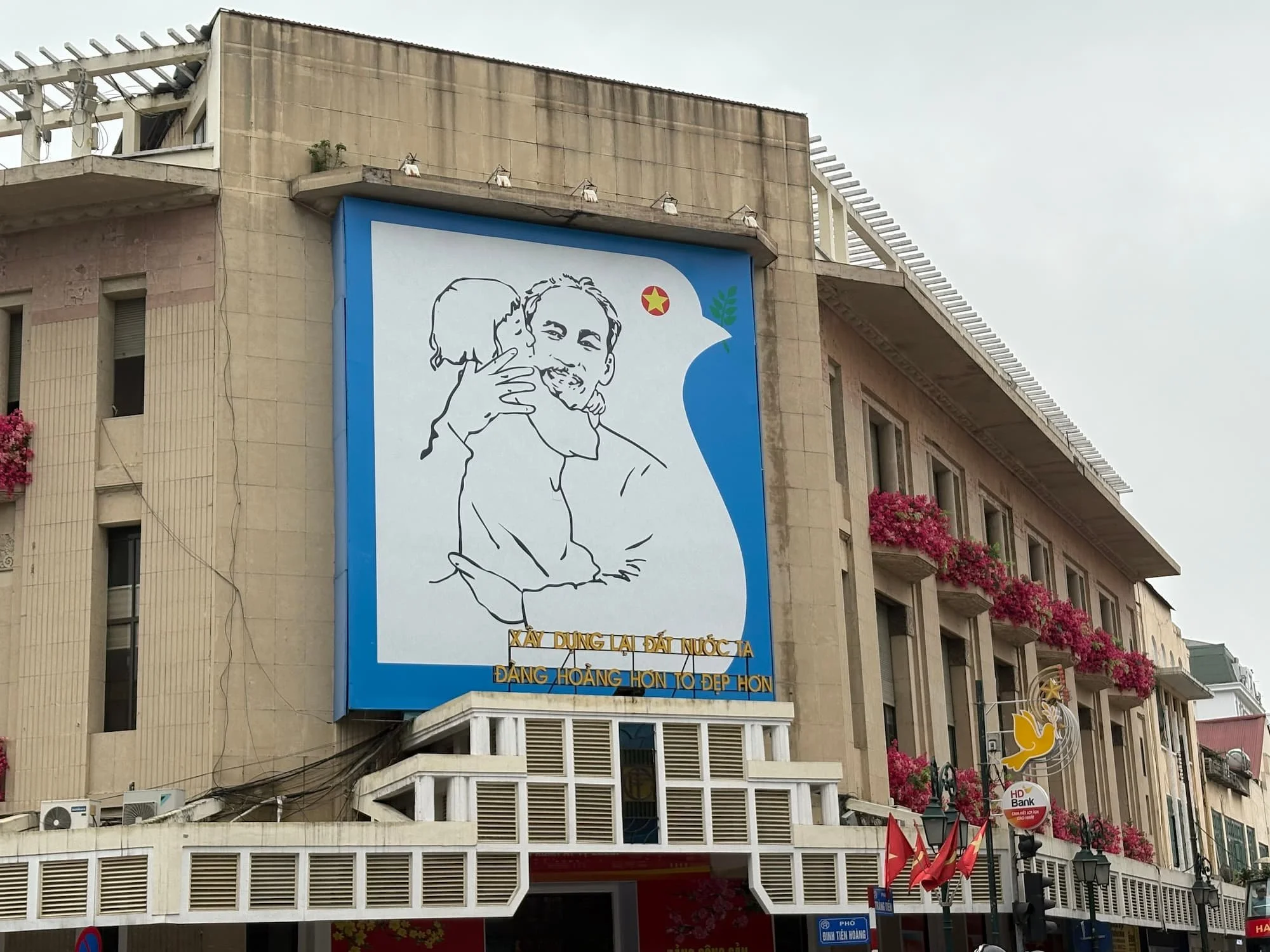 Ho Chi Minh mural on building in the French Quarter of Hanoi in VIetnam