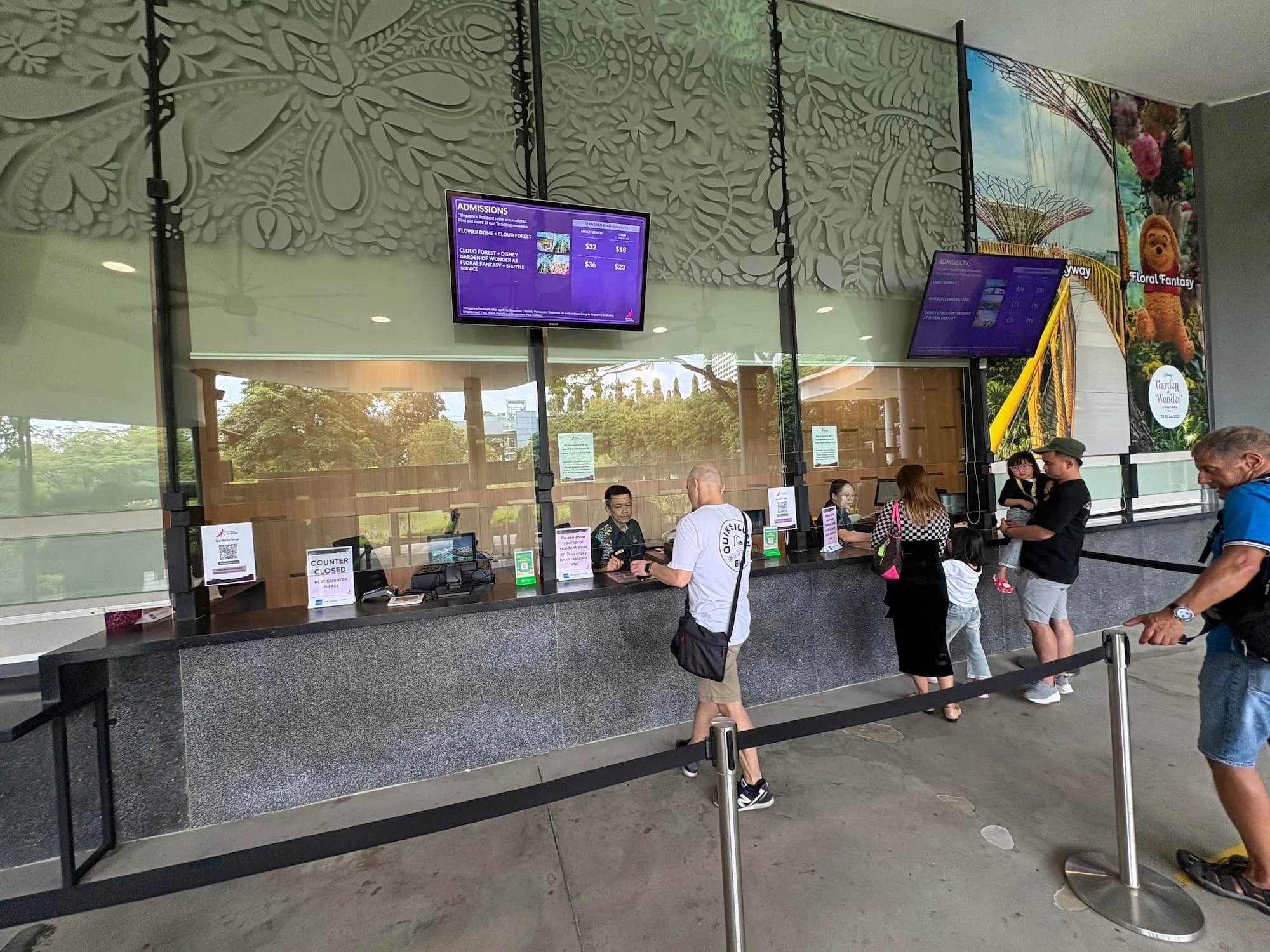 Ticket counters at Gardens by the Bay in Singapore, showing cashless payment systems and digital ticketing screens.