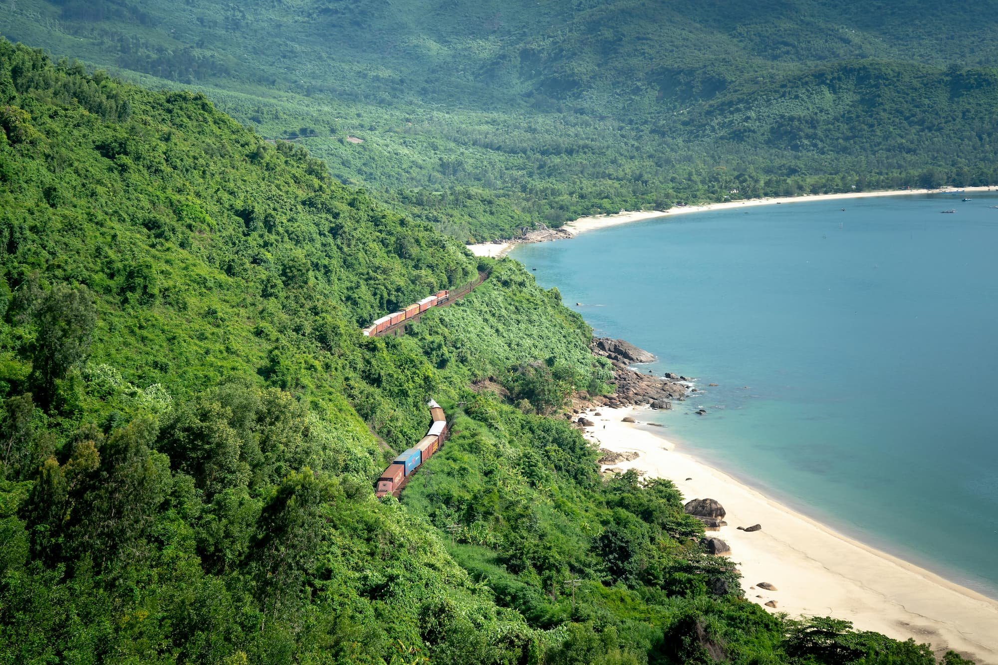 Coastal train in Vietnam travelling through forest