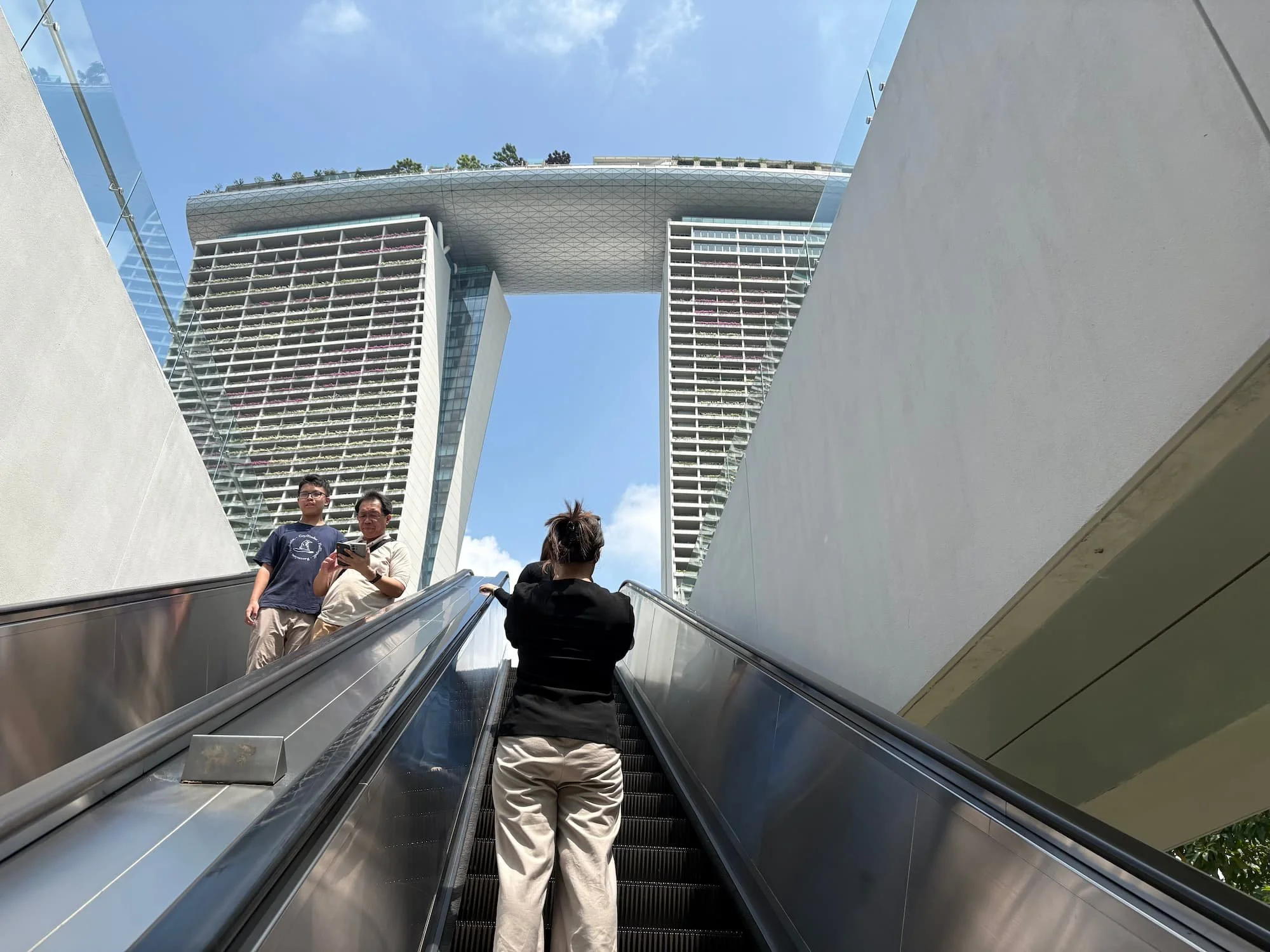 Riding escalators up to view point to see Marina Bay Sands Hotel in Singapore