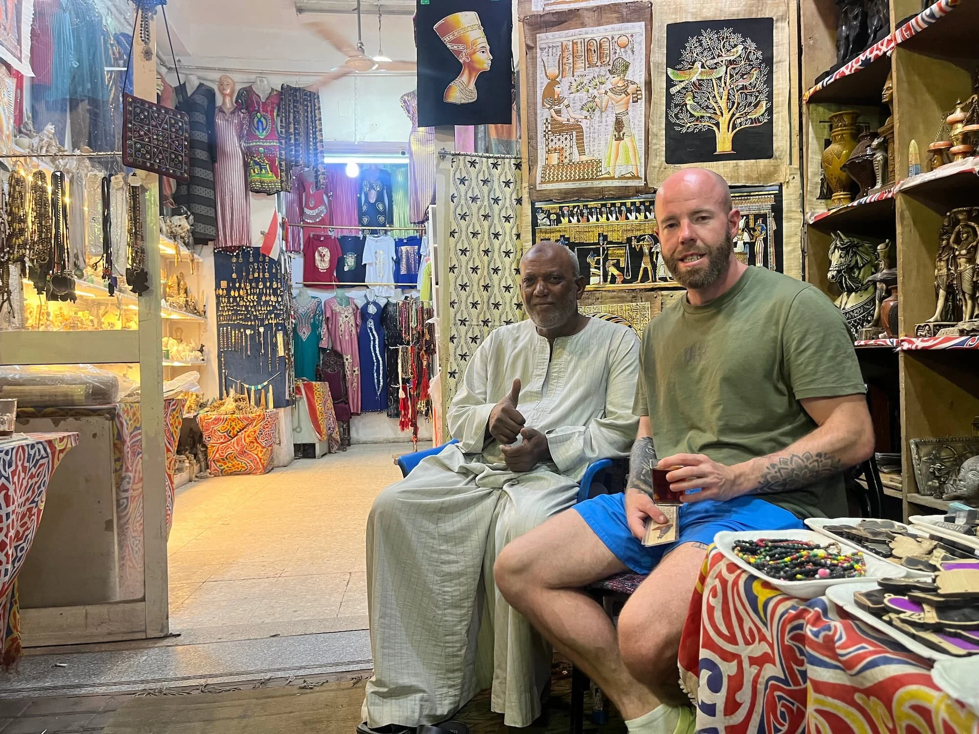Tom Henty with market trader in Luxor market in Egypt