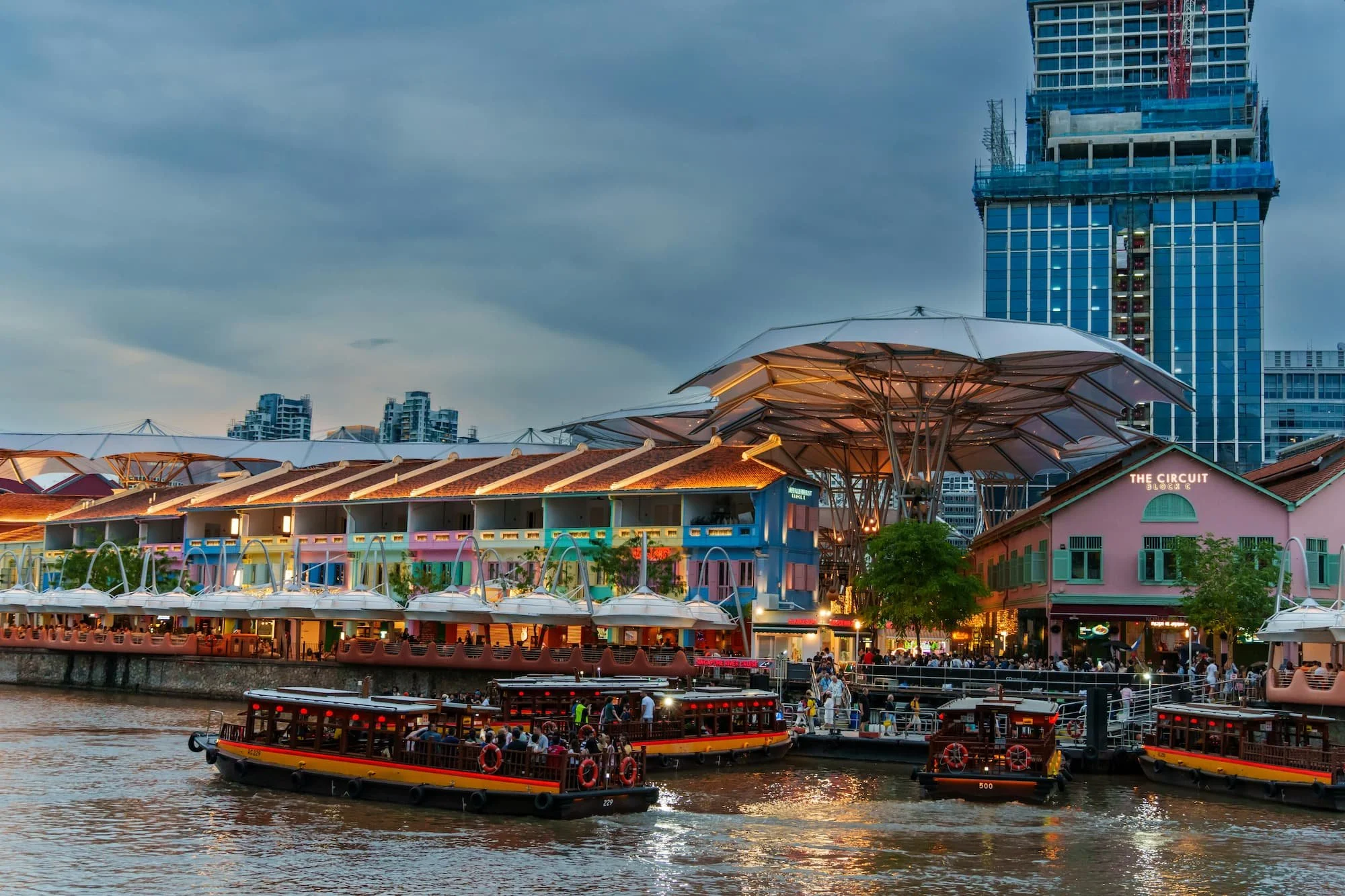 Clarke Quay Riverside lit up in the evening in Singapore