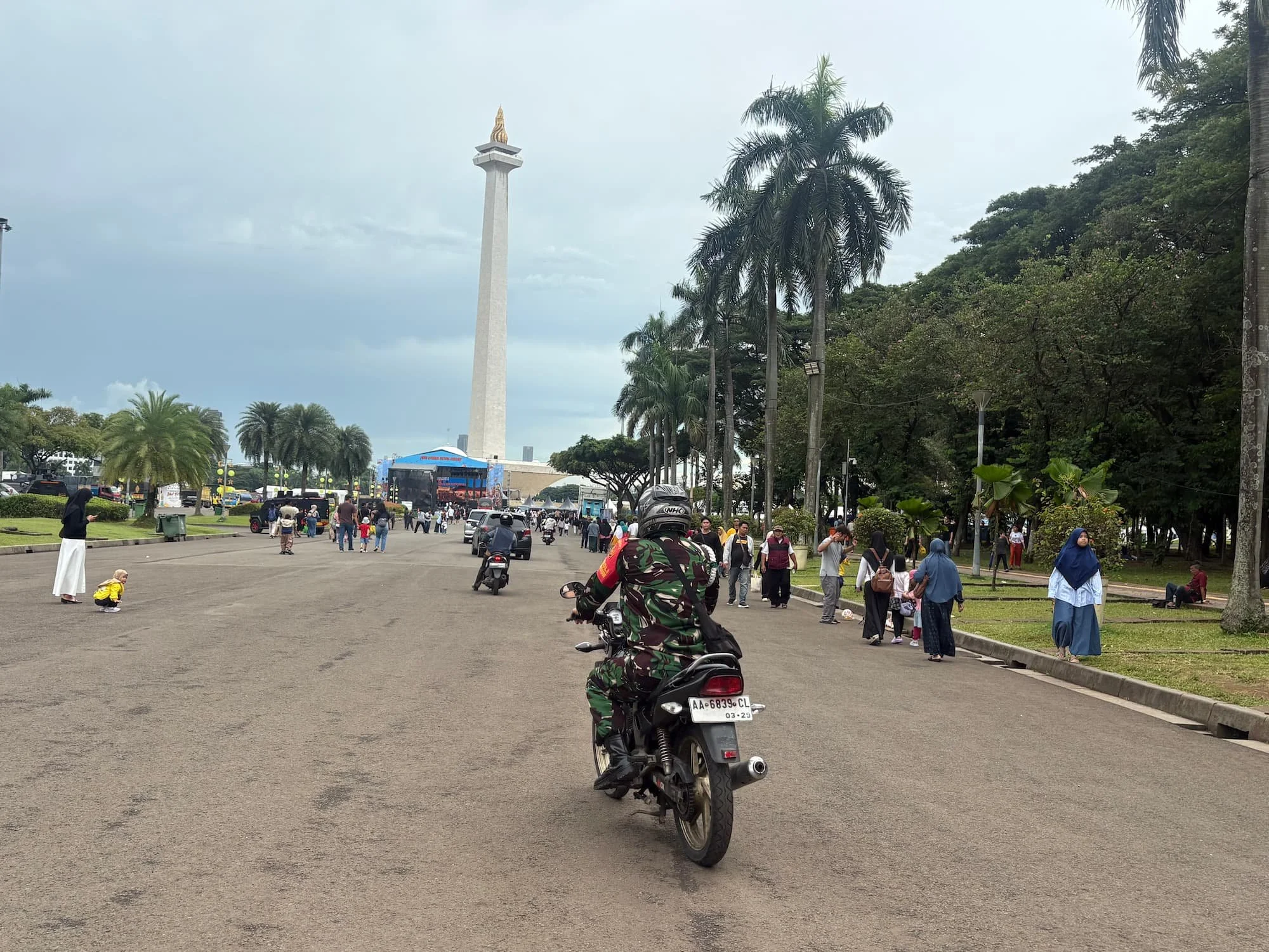 Jakarta street scene near Monas with motorbikes and pedestrians – using an eSIM in Indonesia for navigation
