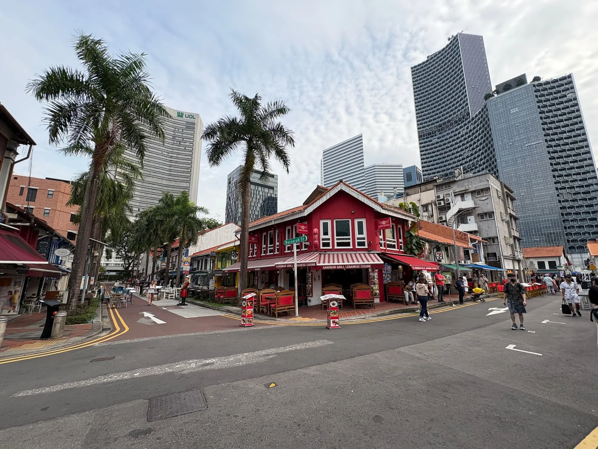 Colourful houses, palm trees and skyscrapers in Kampong Glam in Singapore