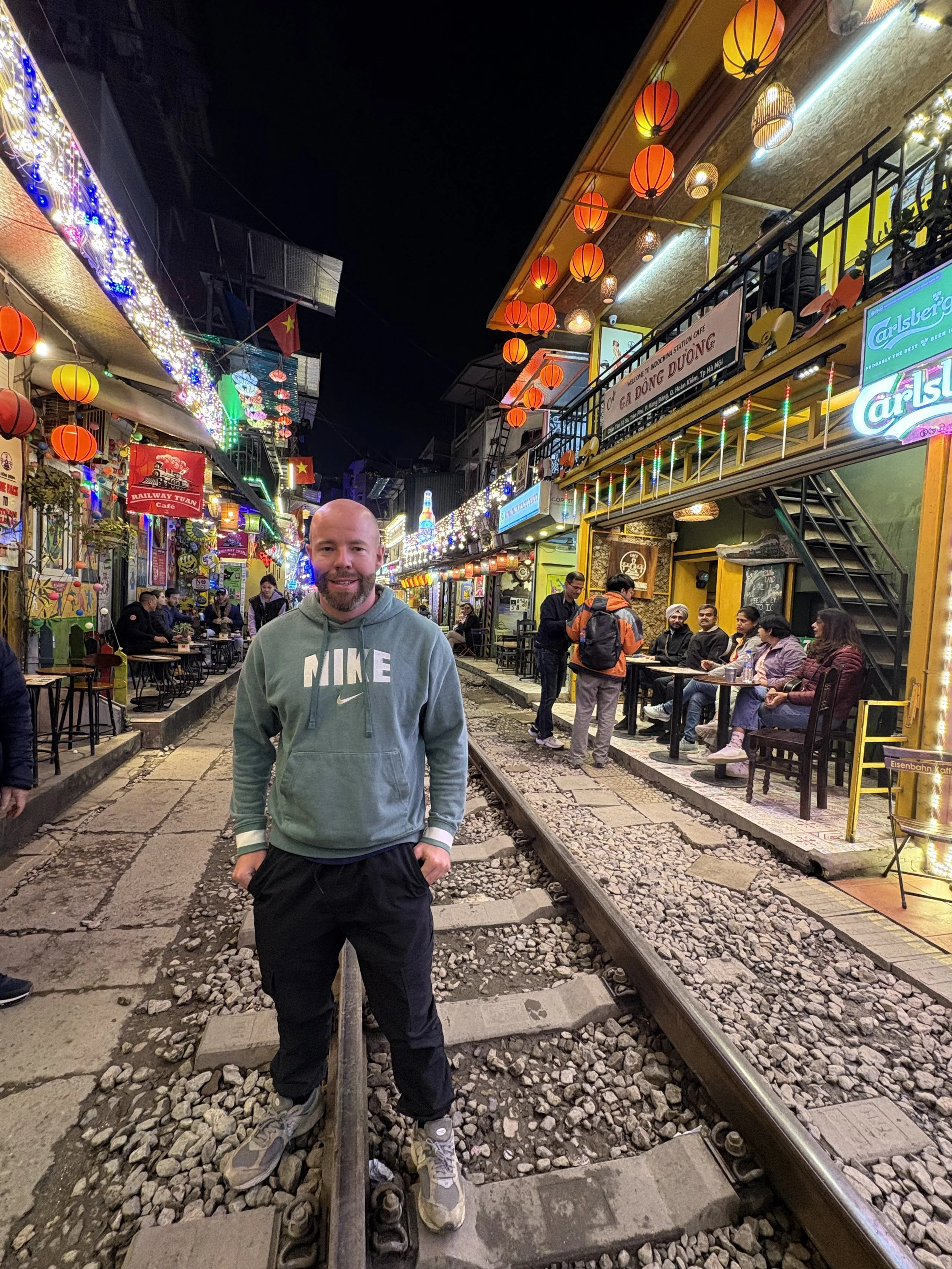 Tom Henty stood on the tracks at Train Street in Hanoi
