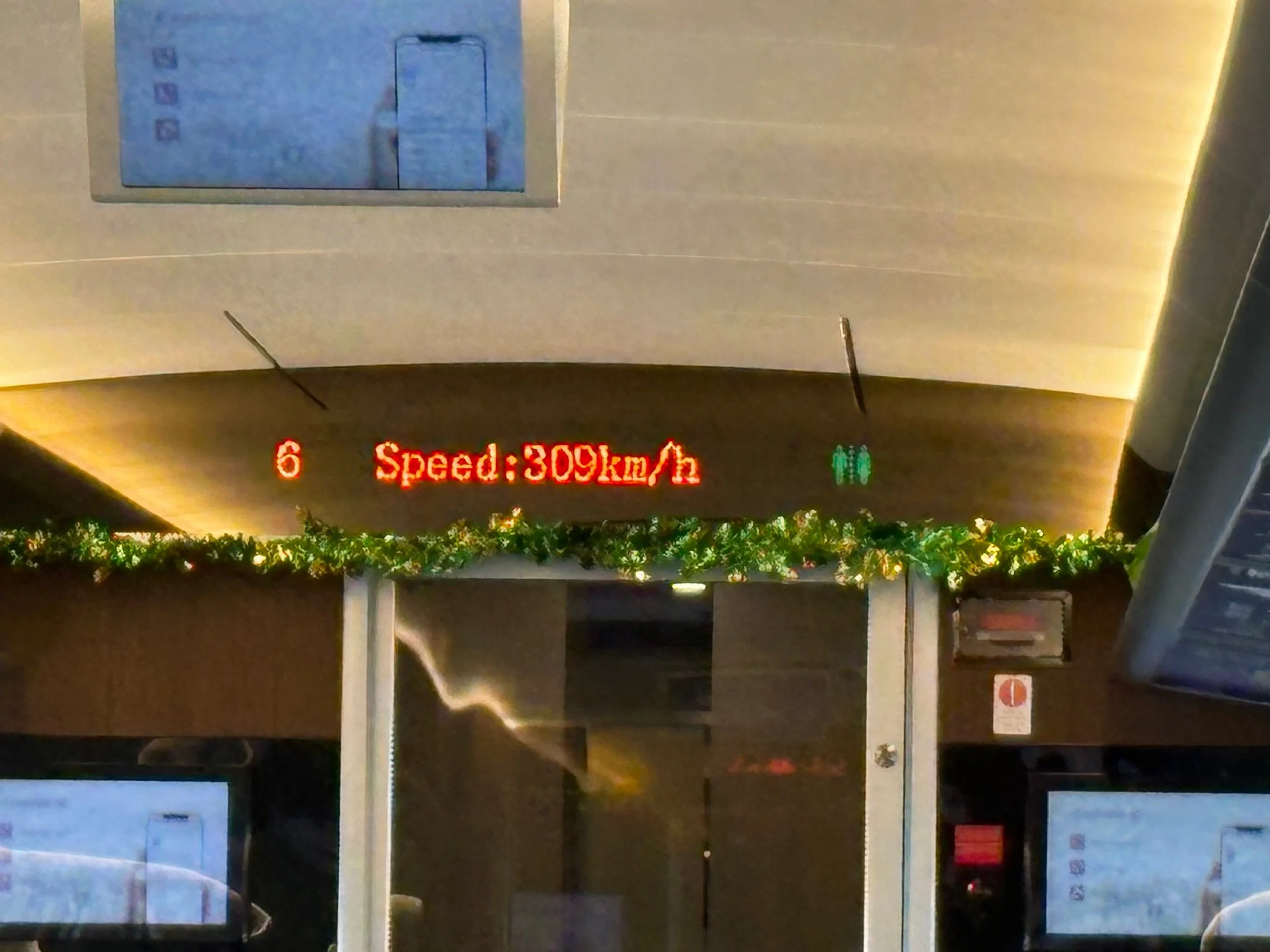 Whoosh high speed train Indonesia showing 309 kmh speed display with reliable mobile data connection
