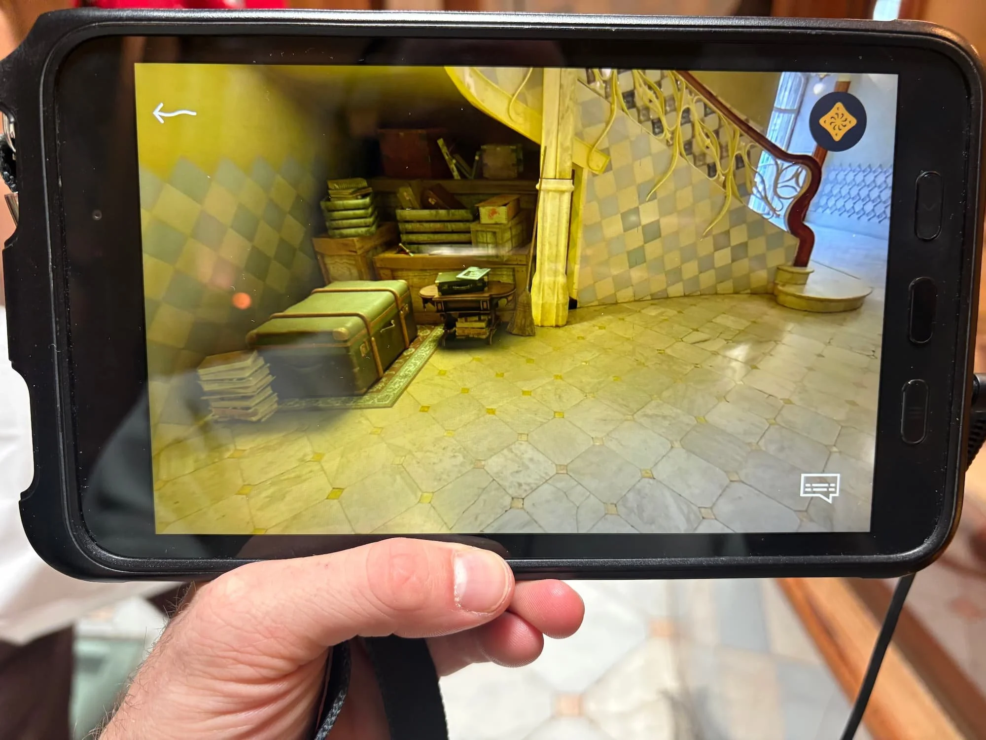 Augmented reality tablet at Casa Batlló showing interactive visual effects and hidden details during the immersive tour experience.