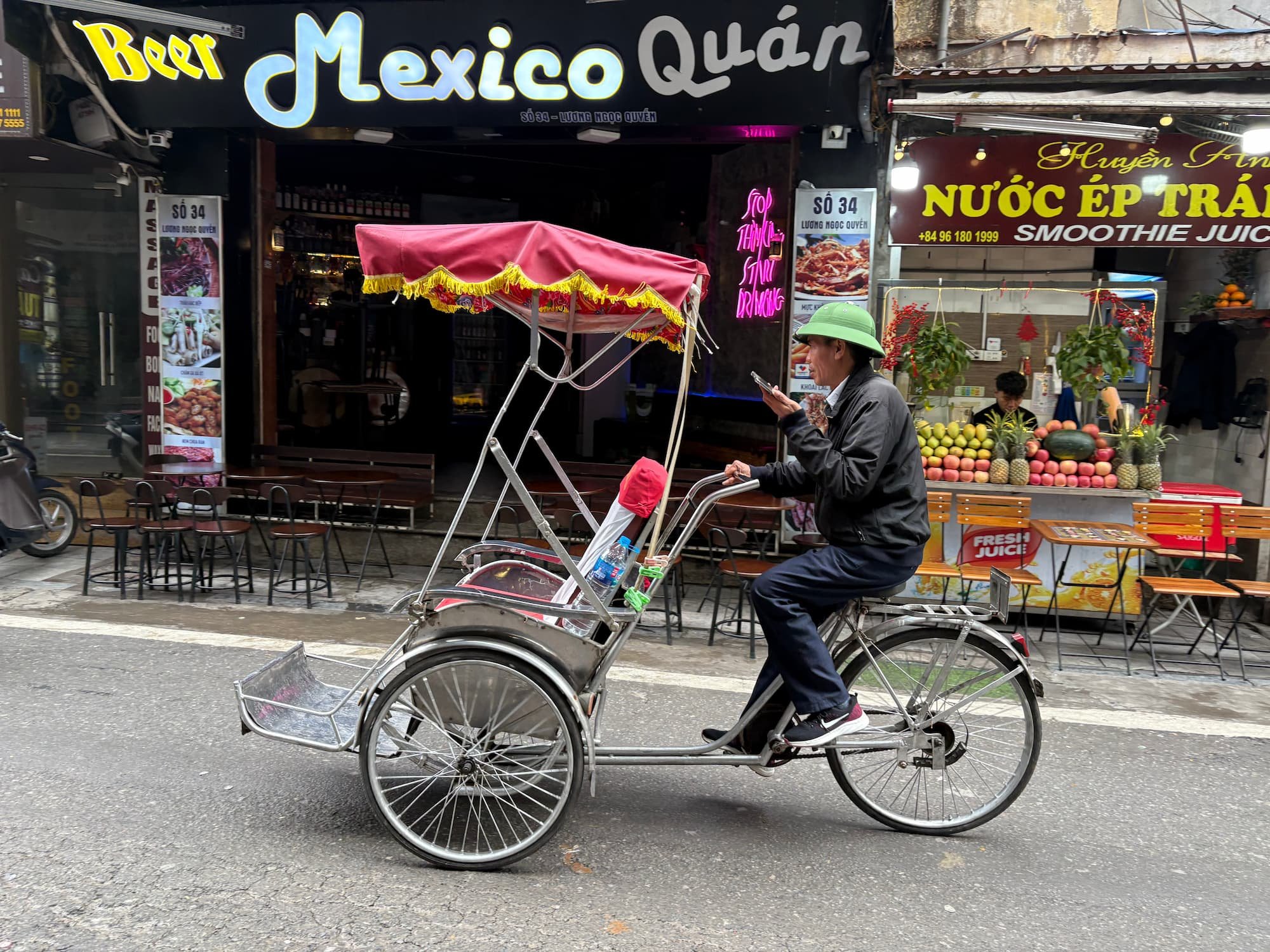 Local riding a rickshaw in Old Quarter of Hanoi in Vietnam