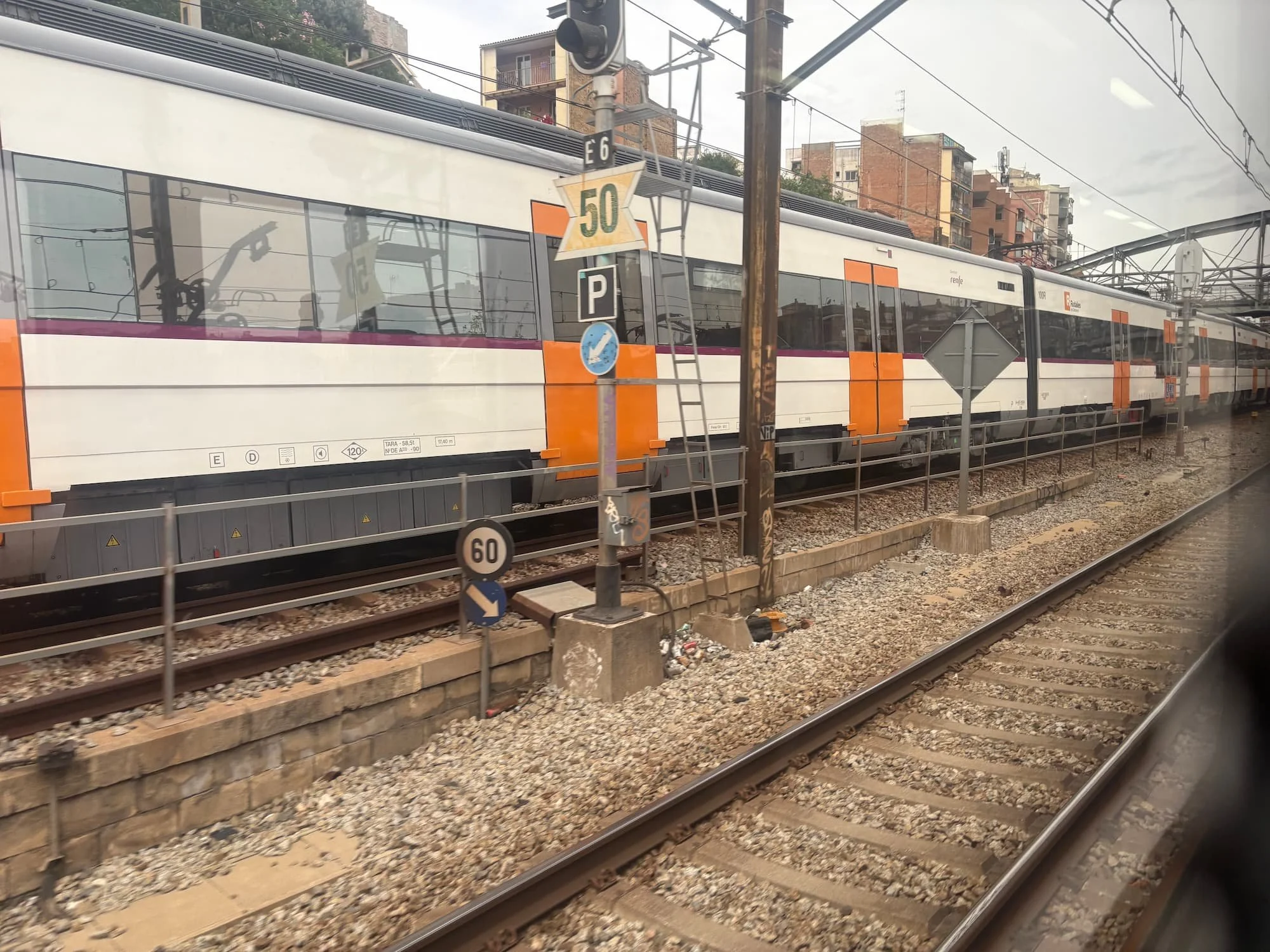 Train travelling through Barcelona's rail network, highlighting the city's efficient public transport system for exploring different neighbourhoods and attractions.